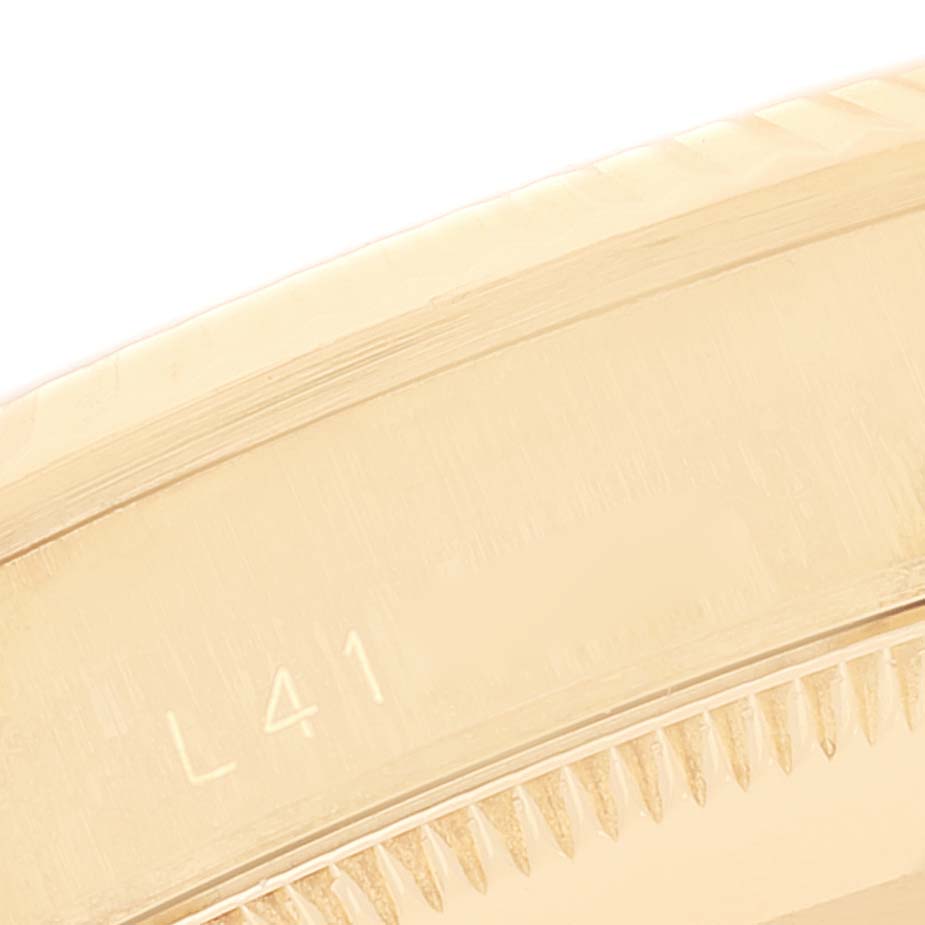 This image shows a close-up of the bezel and part of the engravings on the Rolex President 68278 Women
s Yellow Gold Champagne Dial 68278 Women
s Yellow Gold Champagne Dial model watch.