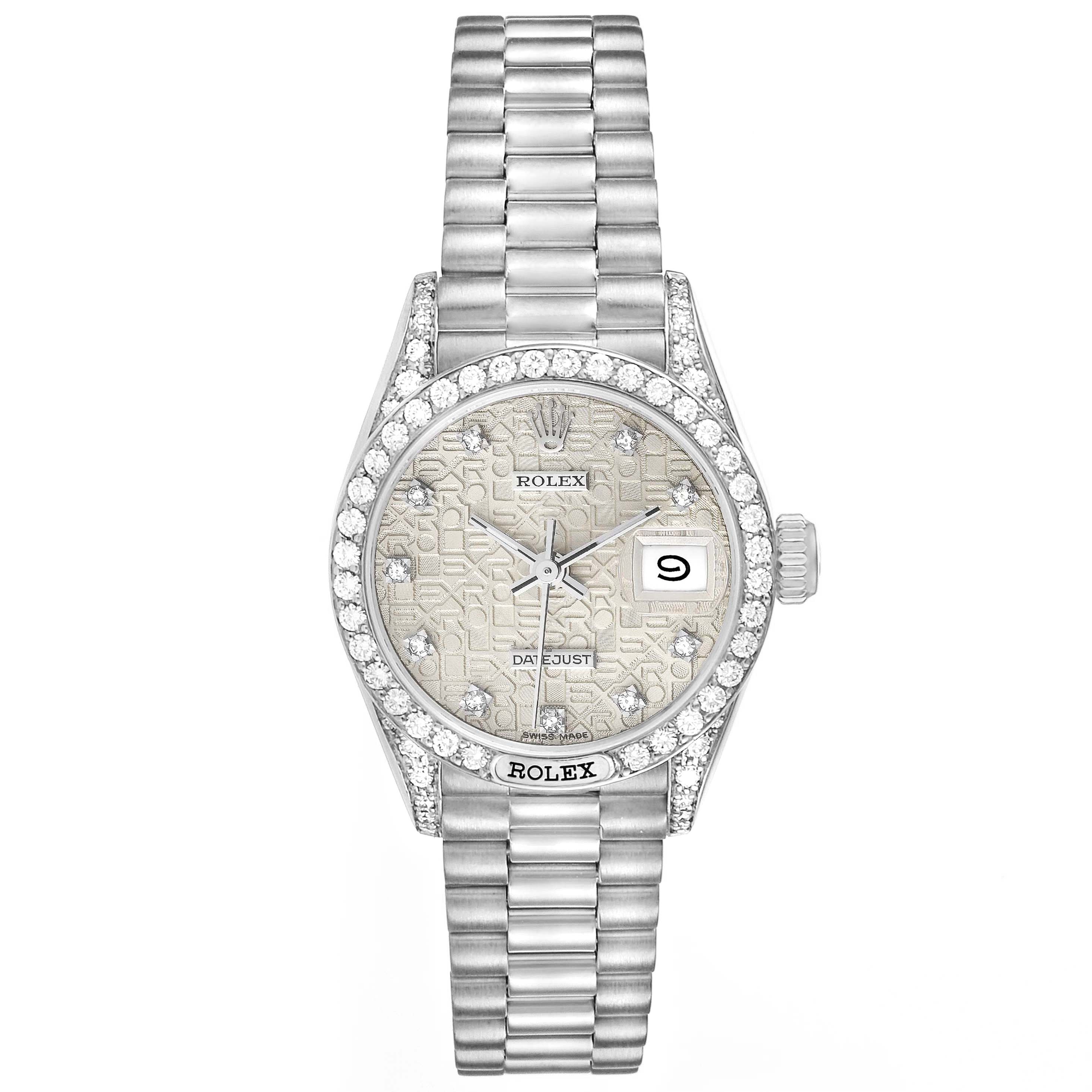 The image shows a front view of a Rolex President 69159 Women's White Gold Silver Dial 69159 Women's White Gold Silver Dial model watch featuring a diamond-encrusted bezel, a patterned dial, and a date display.