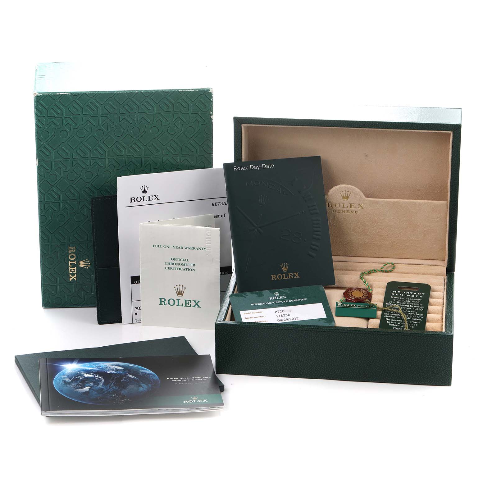 The image shows the packaging for a Rolex Day-Date model 118238, including the box, warranty card, booklets, and tags.
