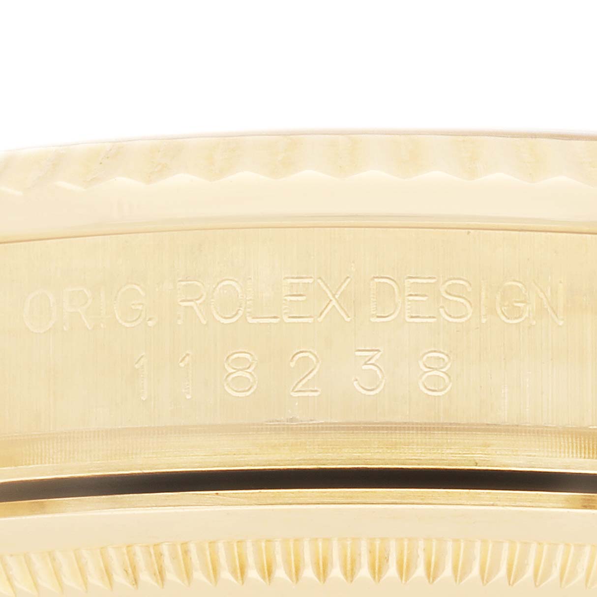The image shows the side engraving of a Rolex Date, model number 118238, displaying "ORIG. ROLEX DESIGN" and the model number on the watch body.