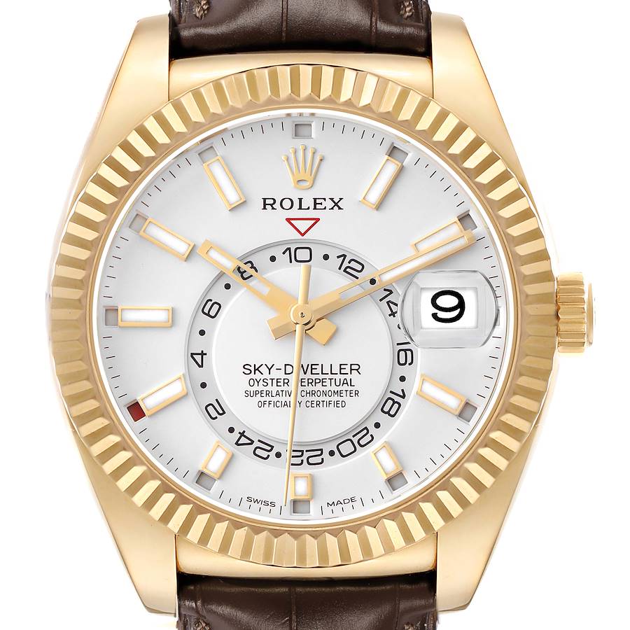The image shows a Rolex Sky-Dweller model 326138 from the front, displaying its face, fluted bezel, and brown leather strap.