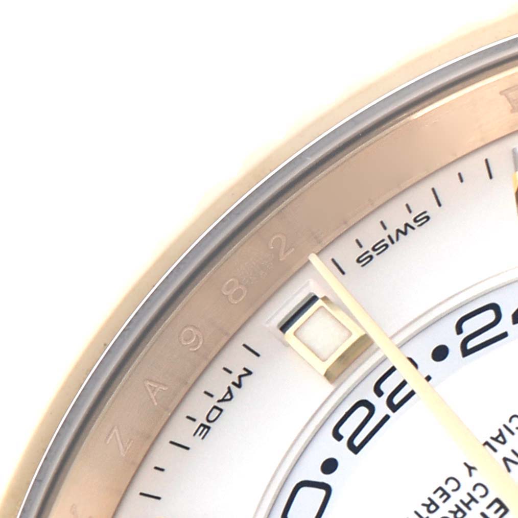The image shows a close-up of the bezel, partial dial, and hands of a Rolex Sky-Dweller model 326138.