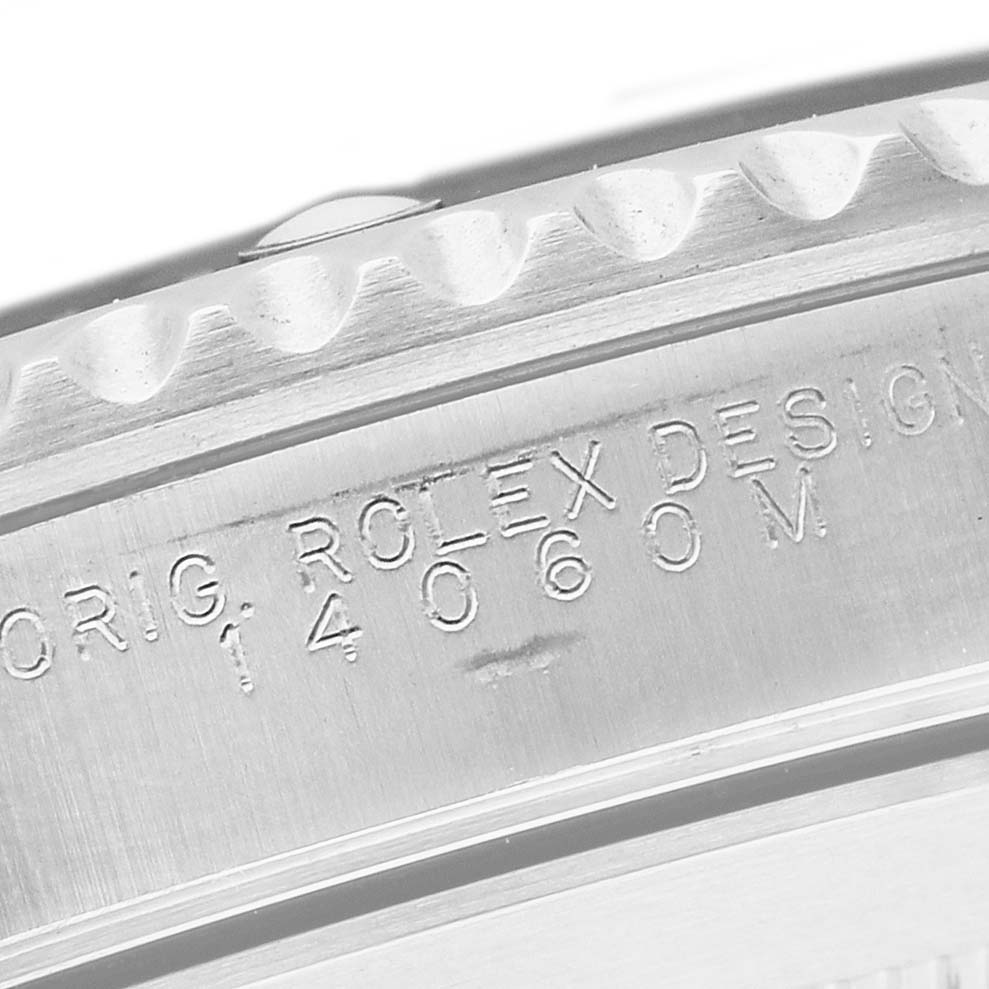 The image shows a close-up of the case side of a Rolex Submariner 14060 Men's Stainless Steel Black Dial, highlighting the engraved model number.
