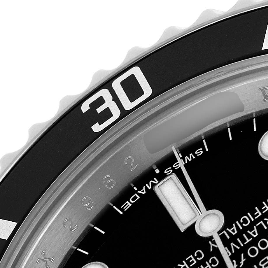 The image shows a close-up of the Rolex Submariner 14060 Men's Stainless Steel Black Dial's bezel, dial, and part of the hour hand.