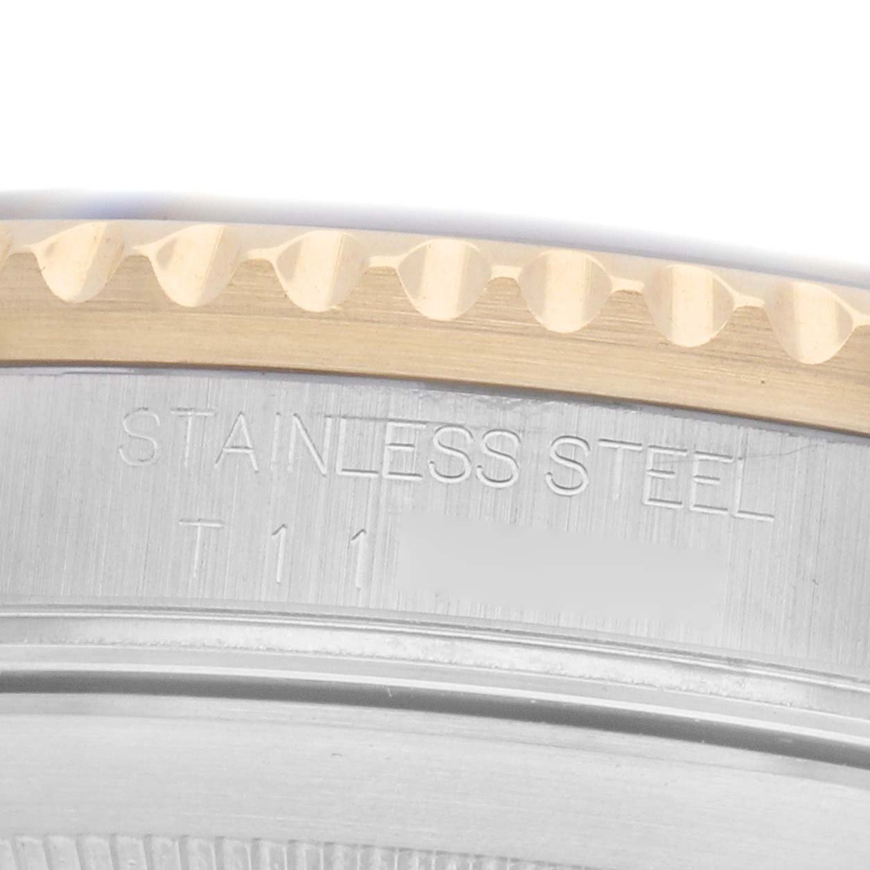 The image shows a close-up side angle of a Rolex Submariner model 16613, focusing on the stainless steel case and part of the bezel edge.