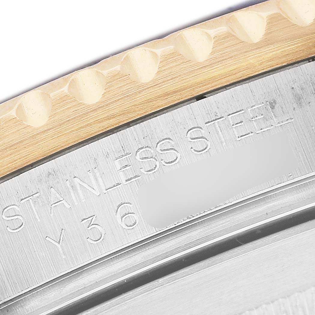 The image shows a close-up of the edge and engraved markings on the bezel of a Rolex Submariner 16613 Men's Steel and Gold (two tone) Blue Dial watch.