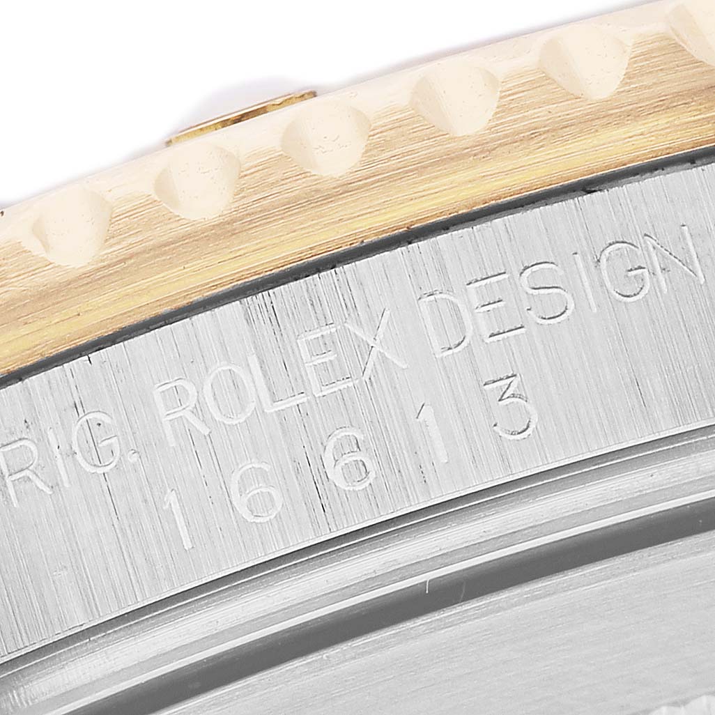 The image shows a close-up of the Rolex Submariner 16613 Men's Steel and Gold (two tone) Blue Dial's side, highlighting the engraved model number and part of the bezel.