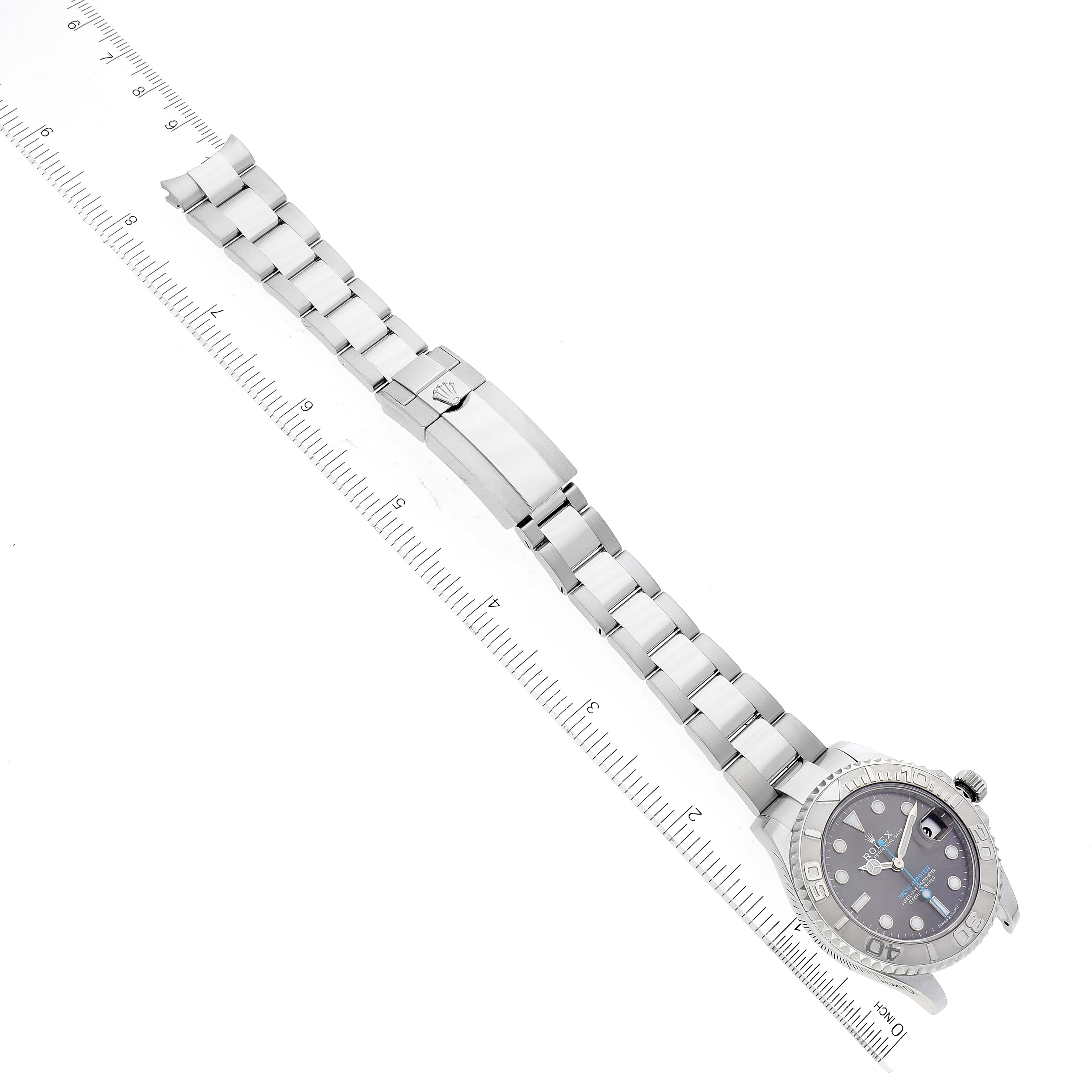 The Rolex Yacht-Master 268622 Men's Stainless Steel Grey Dial 268622 Men's Stainless Steel Grey Dial watch is shown laid flat with the face, bracelet, and clasp visible, measured against a ruler.