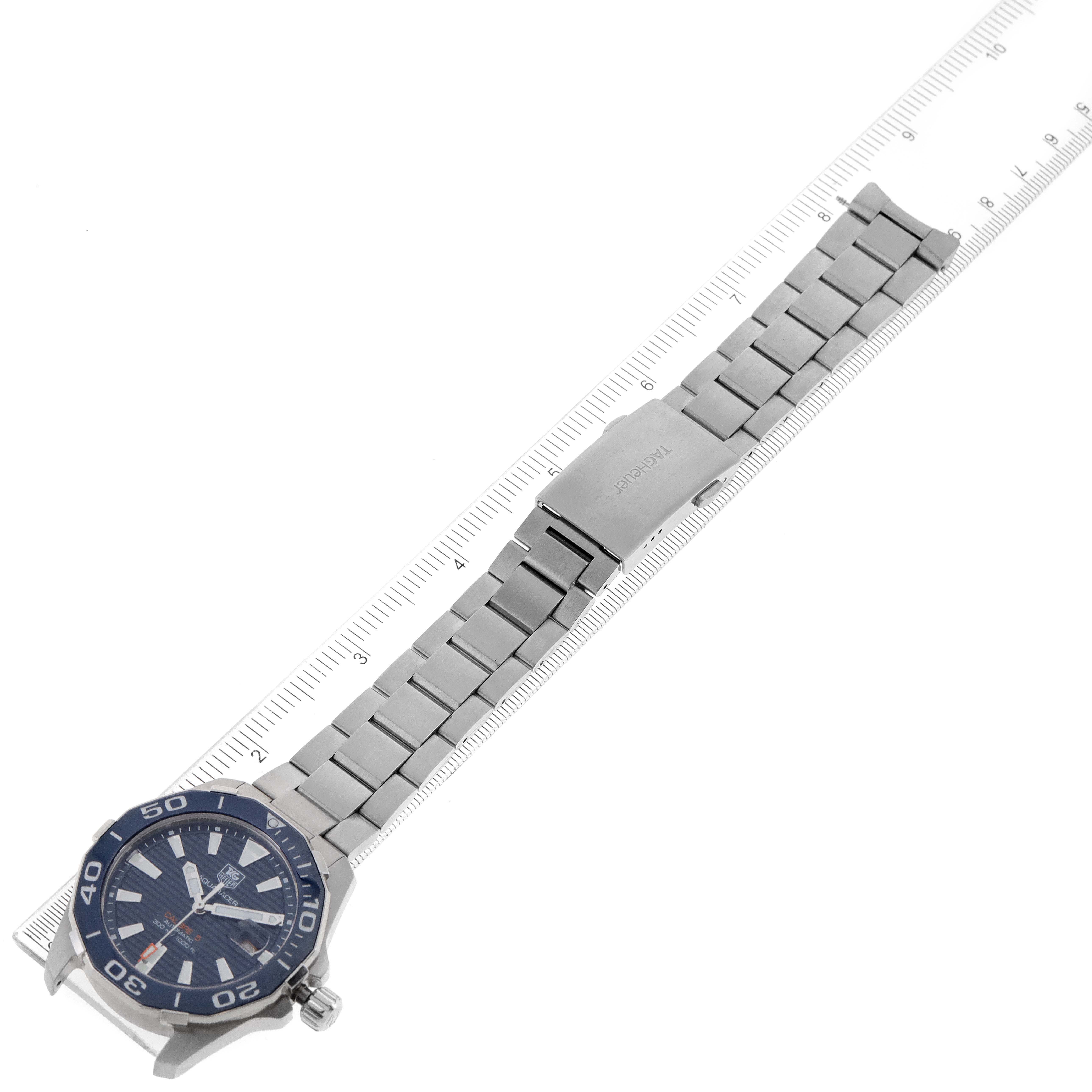 The image showcases the full length of a Tag Heuer Aquaracer WAY211C.BA0928 Men
s Stainless Steel Blue Dial WAY211C.BA0928 Men
s Stainless Steel Blue Dial watch, including its stainless steel bracelet and watch head, from an angled top-down perspective.