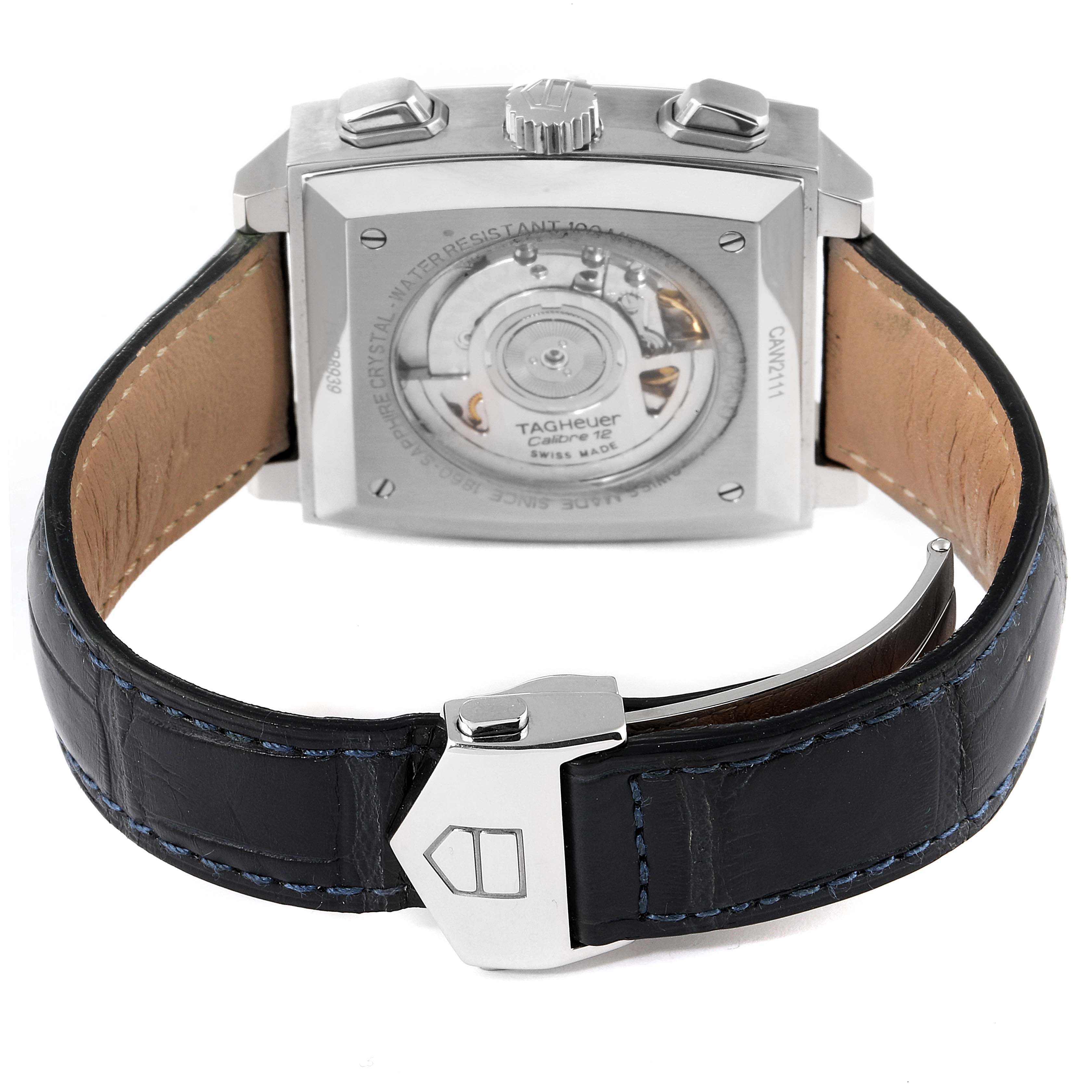 The image shows the back view of a Tag Heuer Monaco CAW2111 Men
s Stainless Steel Blue Dial CAW2111 Men
s Stainless Steel Blue Dial watch, displaying its automatic movement and leather strap with a clasp.