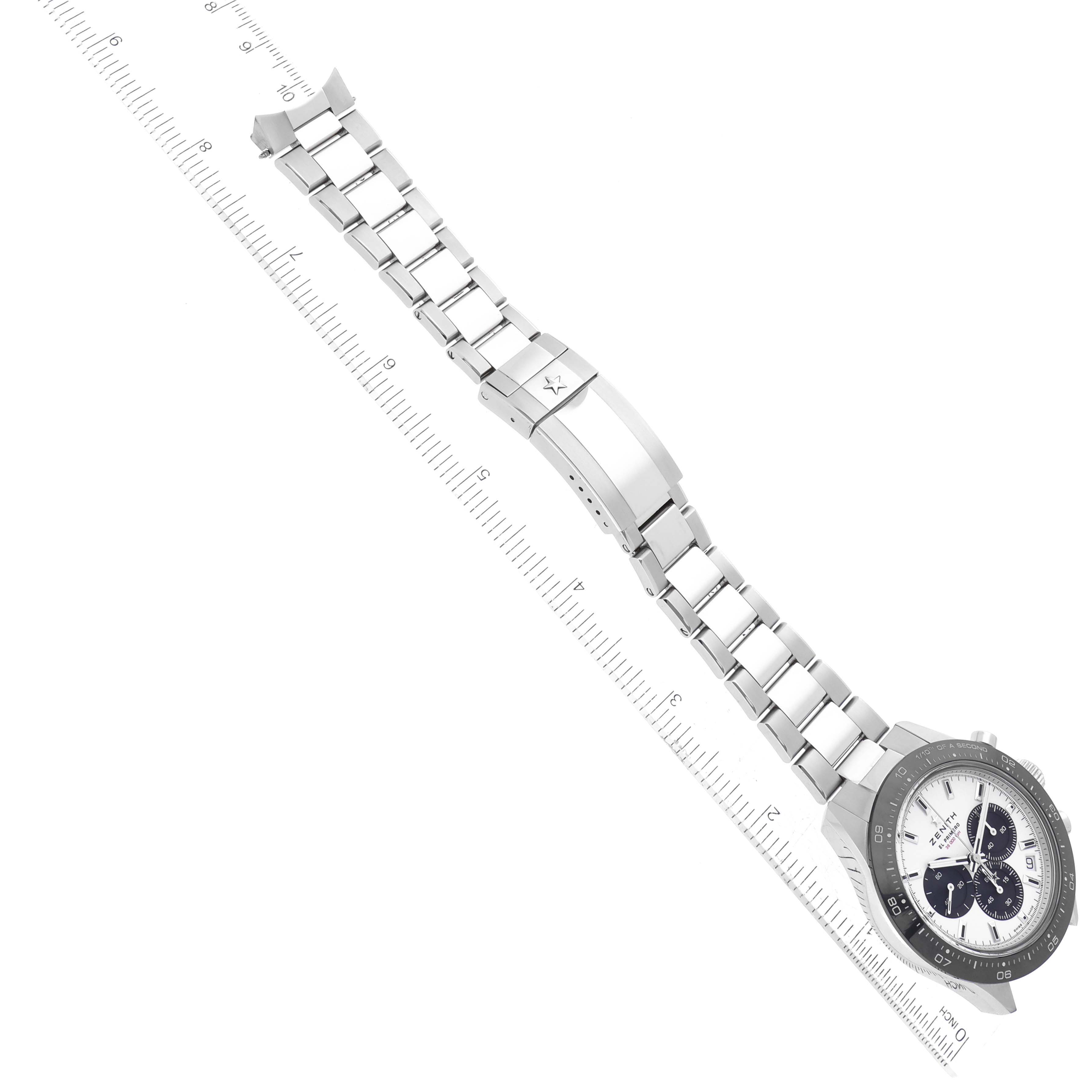 The image shows a Zenith Chronomaster 03.3102.3600 Men's Stainless Steel White Dial 03.3102.3600 Men's Stainless Steel White Dial watch laid flat, highlighting its metal bracelet and clasp alongside a ruler for scale.