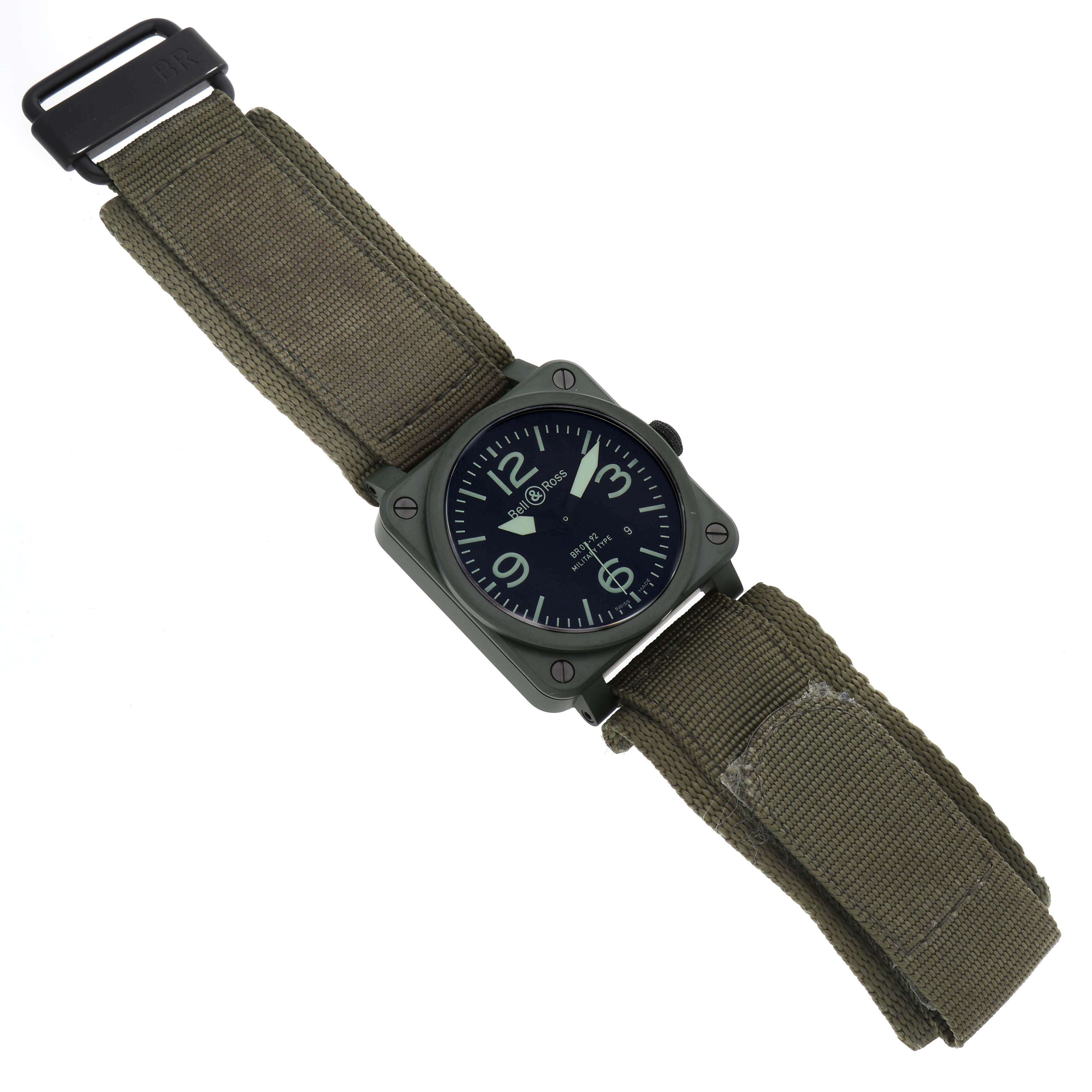The Bell 
Ross Instruments BR03-92-CK Men
s Ceramic Black Dial BR03-92-CK Men
s Ceramic Black Dial model watch is shown from a top-down angle, displaying the face and khaki fabric strap.