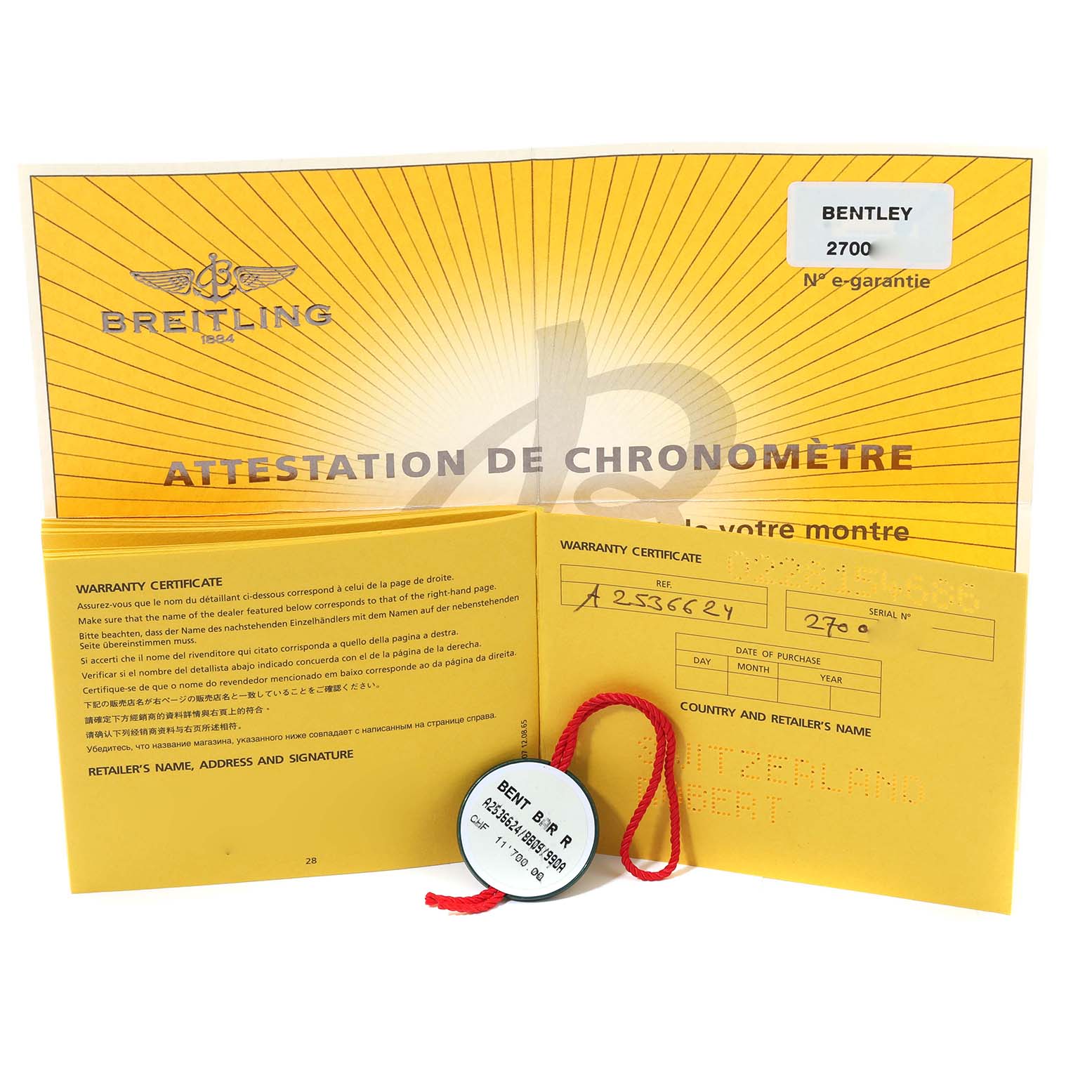 The image shows the warranty certificate and attestation documents for the Bentley model by Breitling, along with a tagged seal.