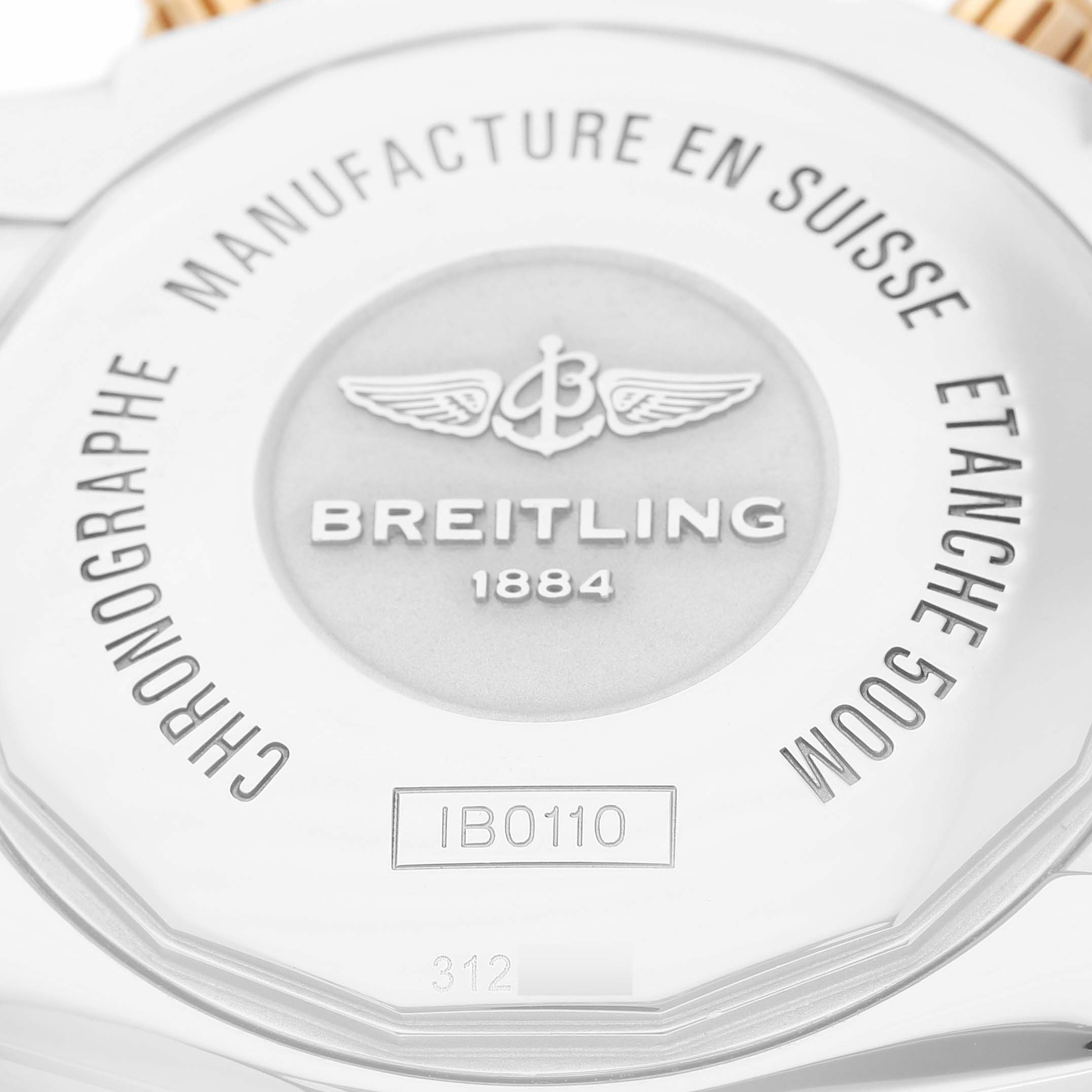The image shows the case back of a Breitling Chronomat IB0110 Men's Steel and Gold (two tone) Black Dial watch, highlighting the brand name and model details.