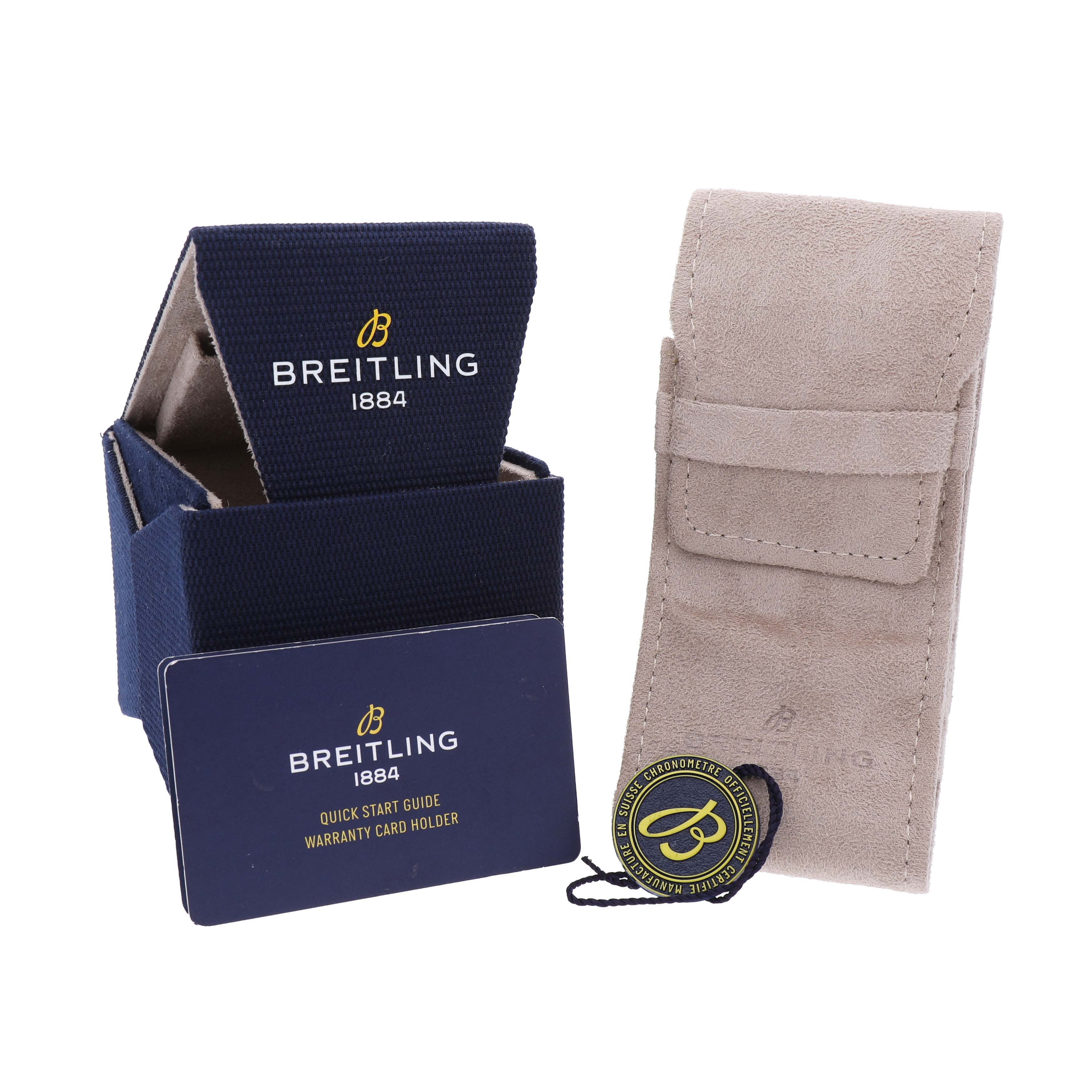 The image shows the Breitling Navitimer AB0137 Men's Stainless Steel Green Dial's packaging, a warranty card holder, and a suede pouch, all placed upright.