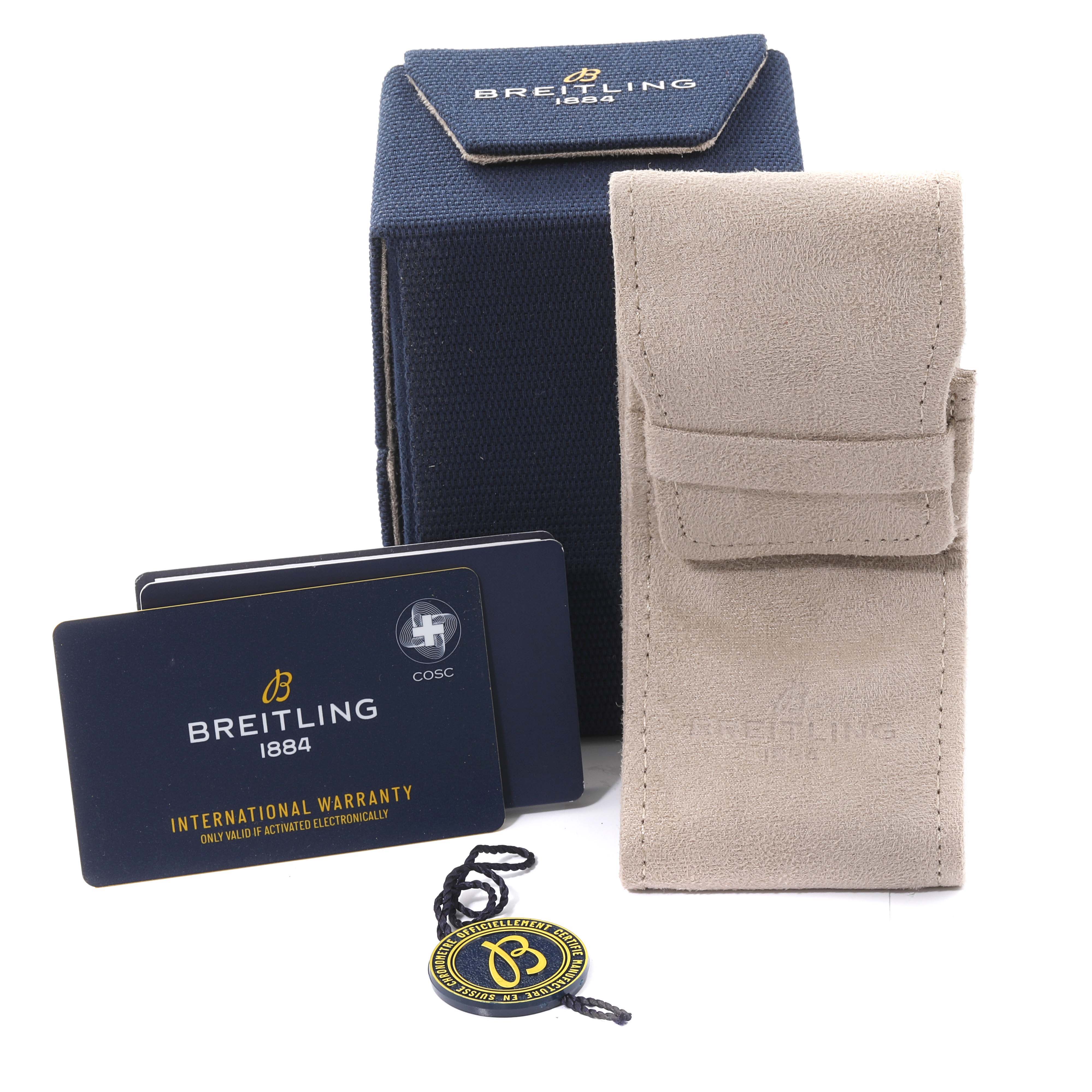 The image shows Breitling Superocean N17375 Men
s Yellow Gold Green Dial N17375 Men
s Yellow Gold Green Dial watch accessories including a blue box, beige pouch, warranty cards, and a tag.