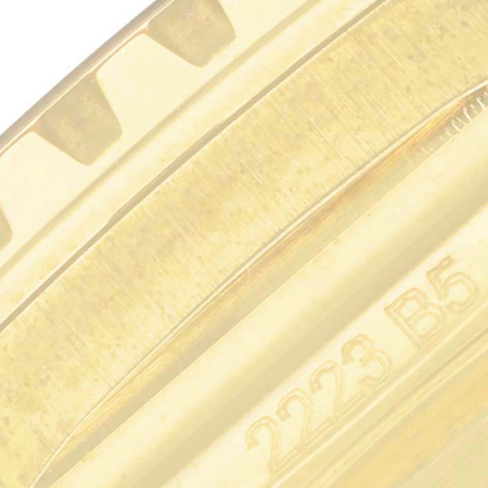The image shows a close-up of the bezel and part of the case back of a Breitling Superocean N17375 Men
s Yellow Gold Green Dial N17375 Men
s Yellow Gold Green Dial watch, displaying some engraved numbers.