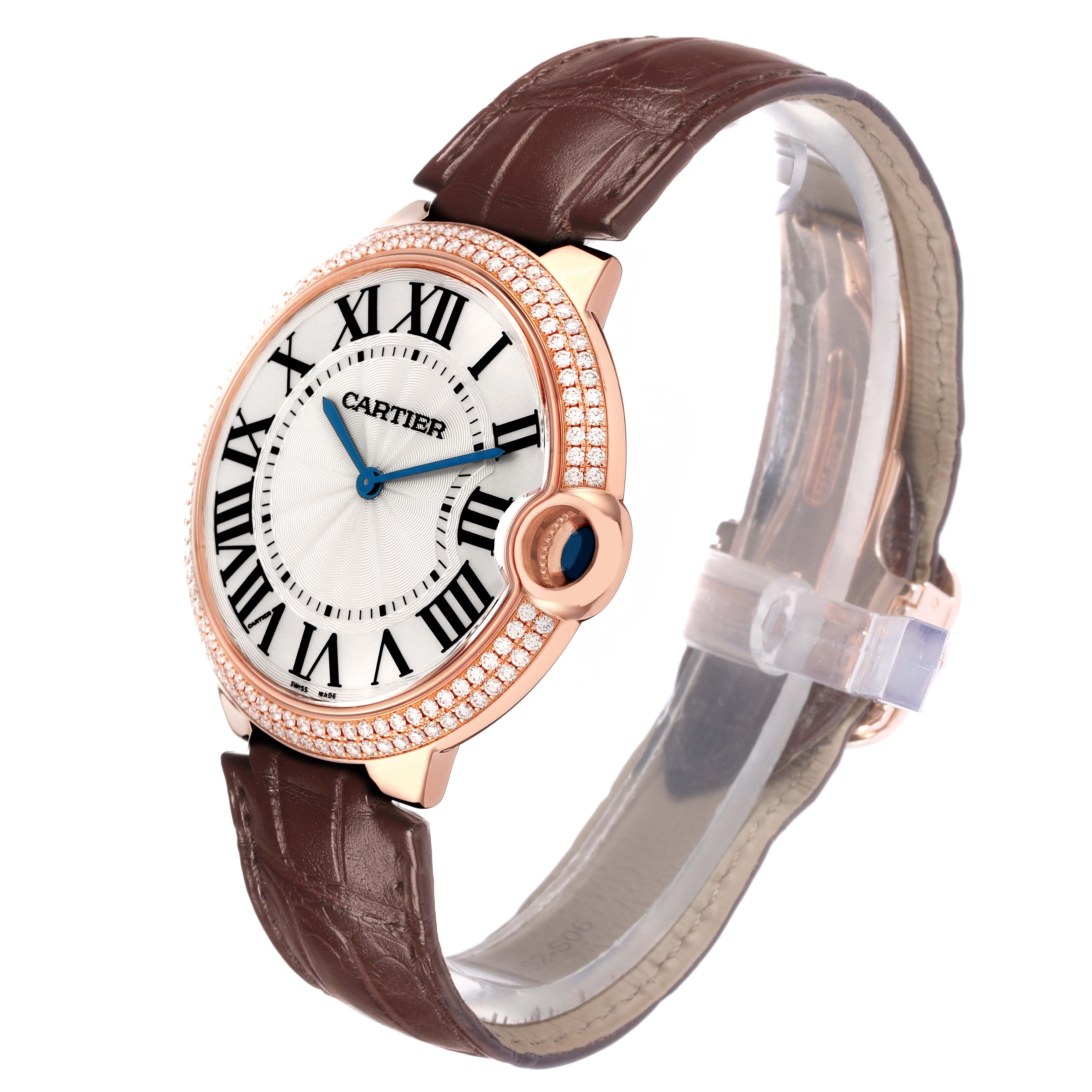 The Cartier Ballon Bleu WE902055 men
s watch is shown at a three-quarter angle highlighting its round diamond-set bezel, brown leather strap, and Roman numeral dial.