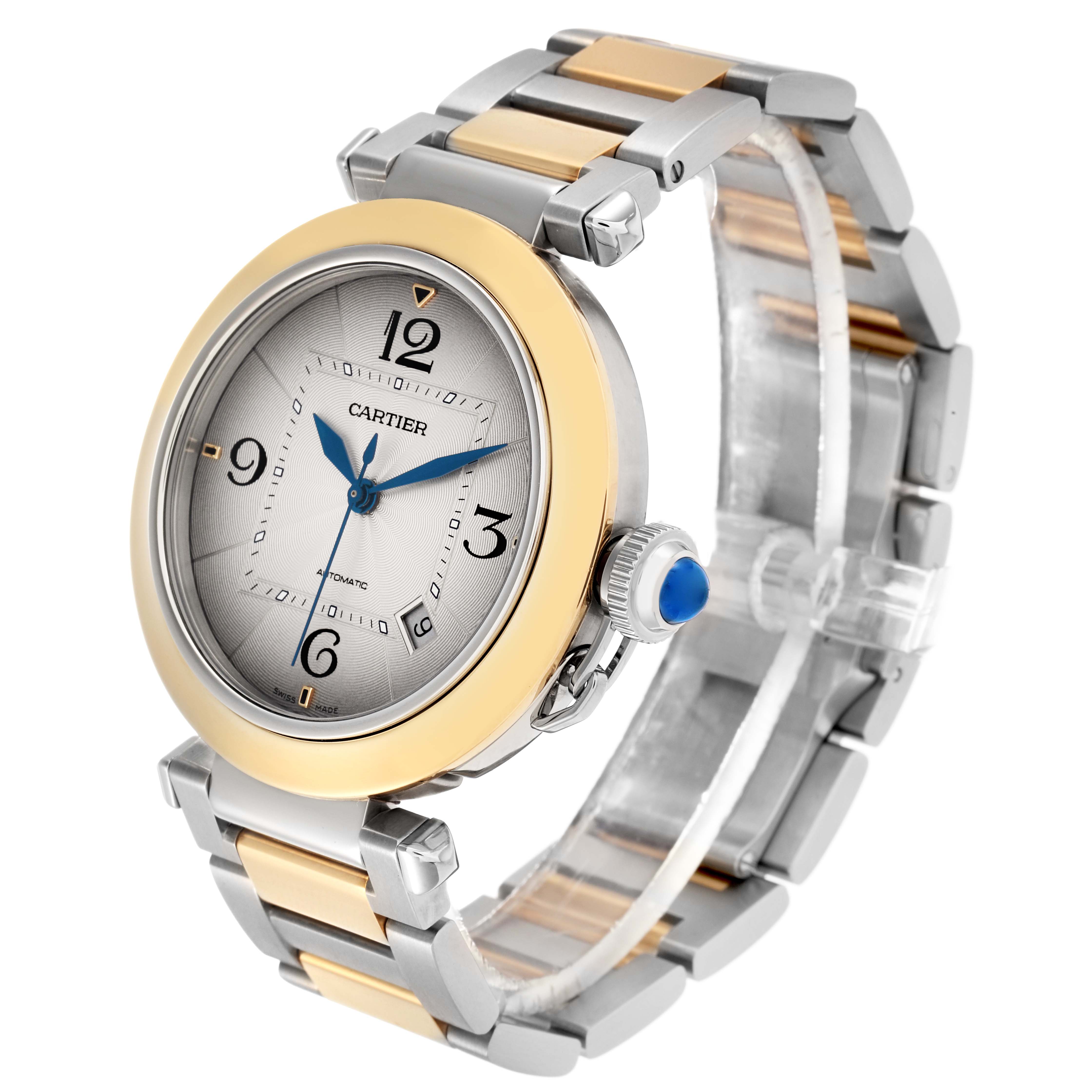 The Cartier Pasha model W2PA0009 is shown at a three-quarter angle, highlighting the watch face, bezel, crown, and metal bracelet.