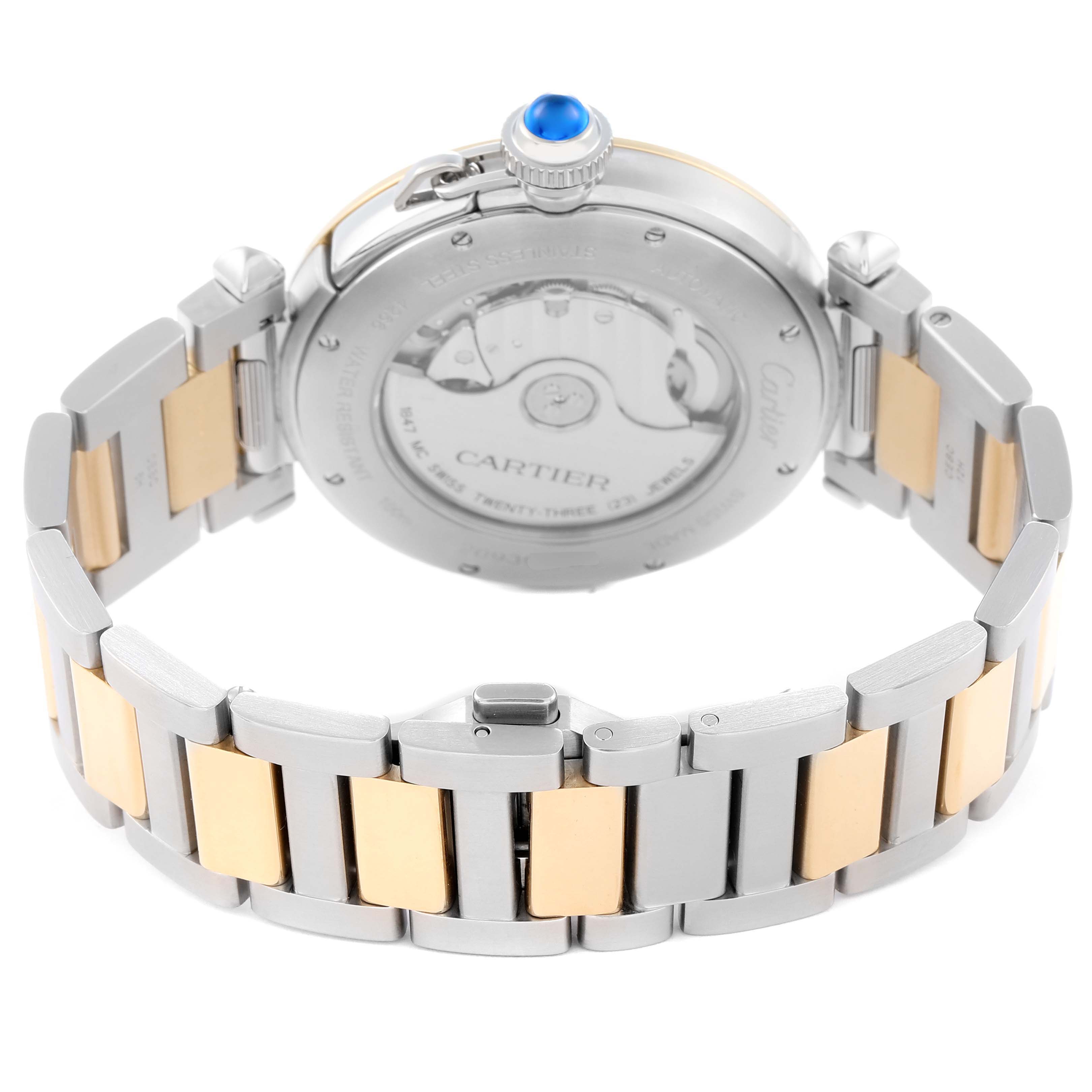 The image shows the back view of the Cartier Pasha model W2PA0009, highlighting the exhibition case back, two-tone bracelet, and crown with a blue cabochon.