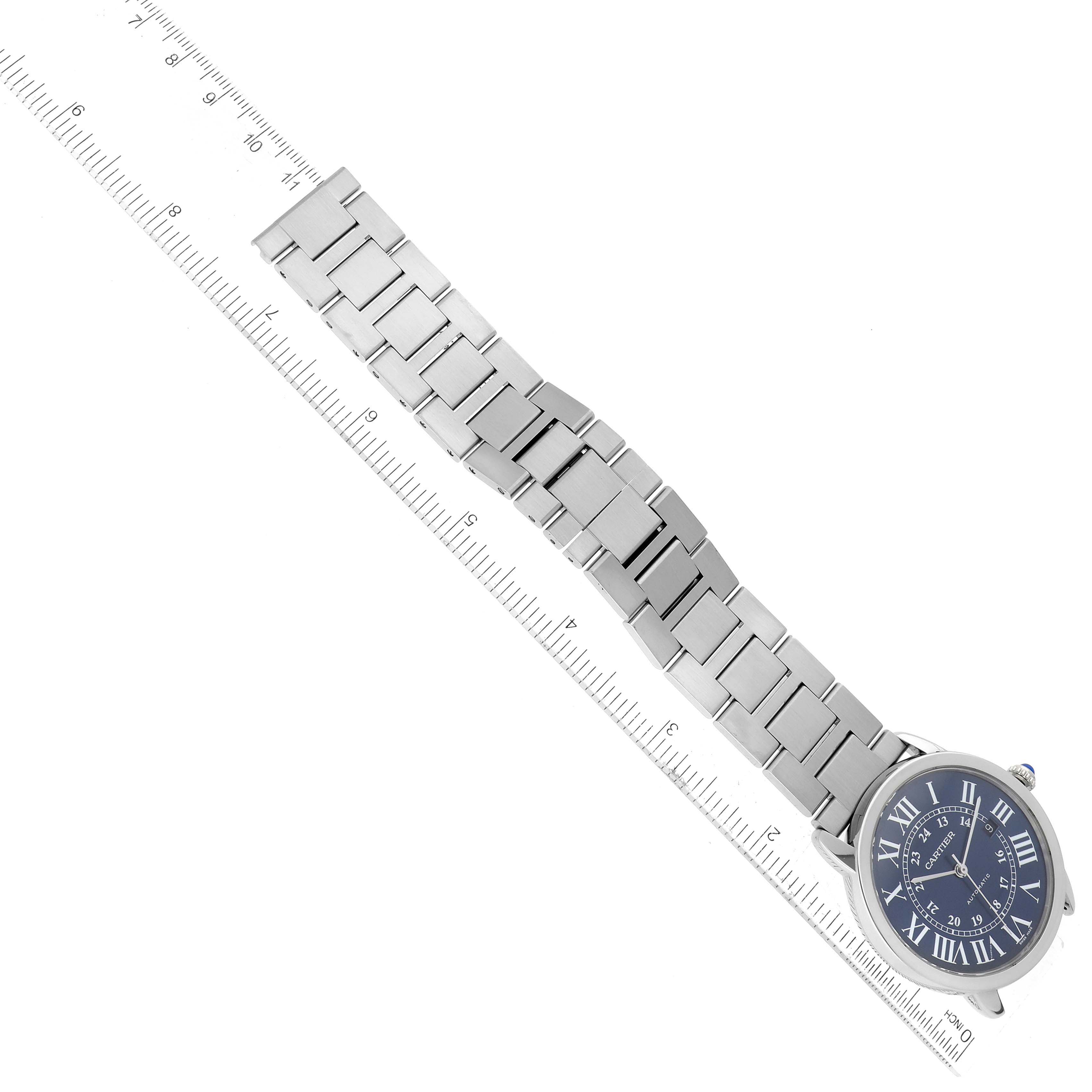The image shows a Cartier Ronde WSRN0023 Men's Stainless Steel Blue Dial WSRN0023 Men's Stainless Steel Blue Dial model watch laid flat with a ruler measuring the length of its metal bracelet.