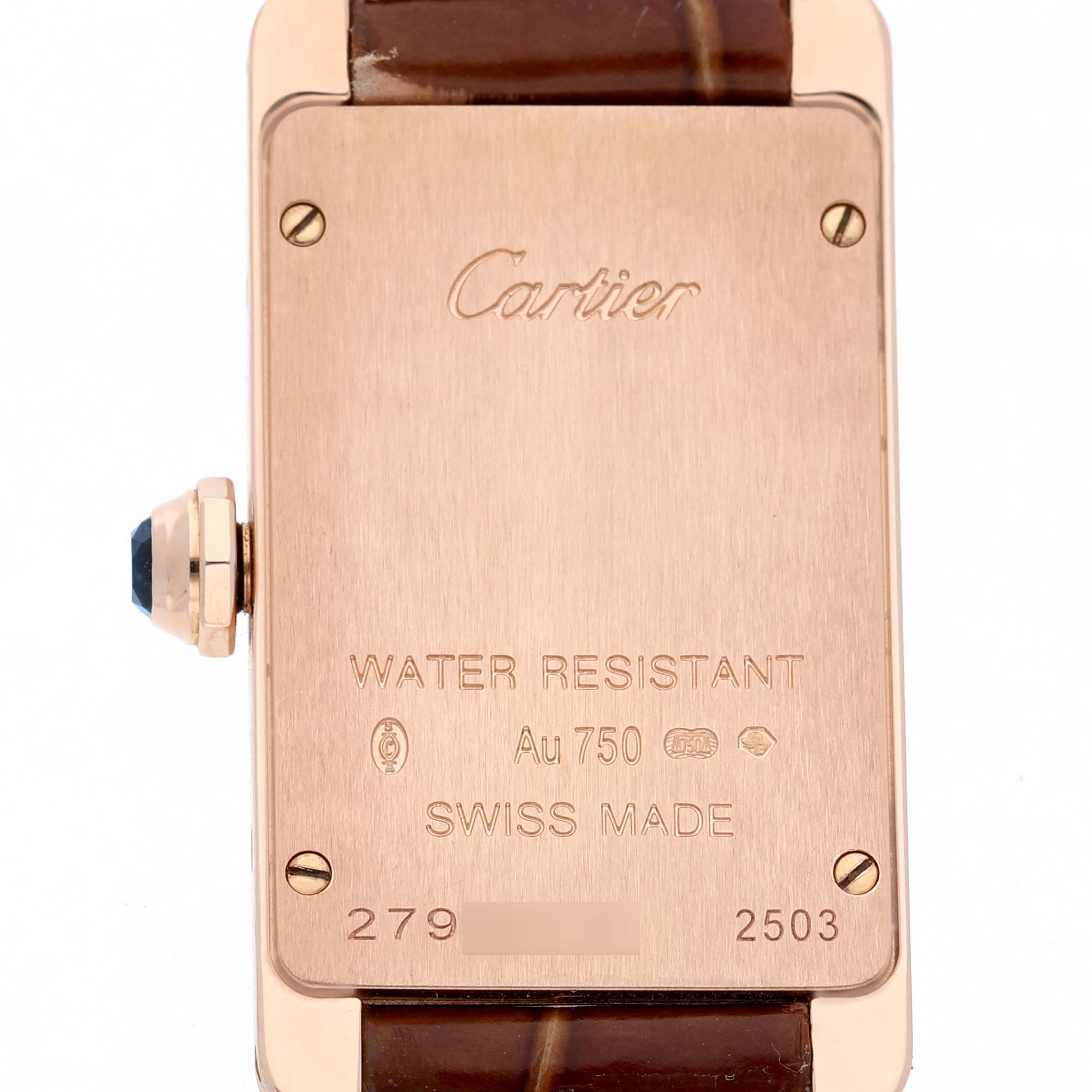 The image shows the back of a Cartier Tank Américaine watch, highlighting the caseback details and leather strap.