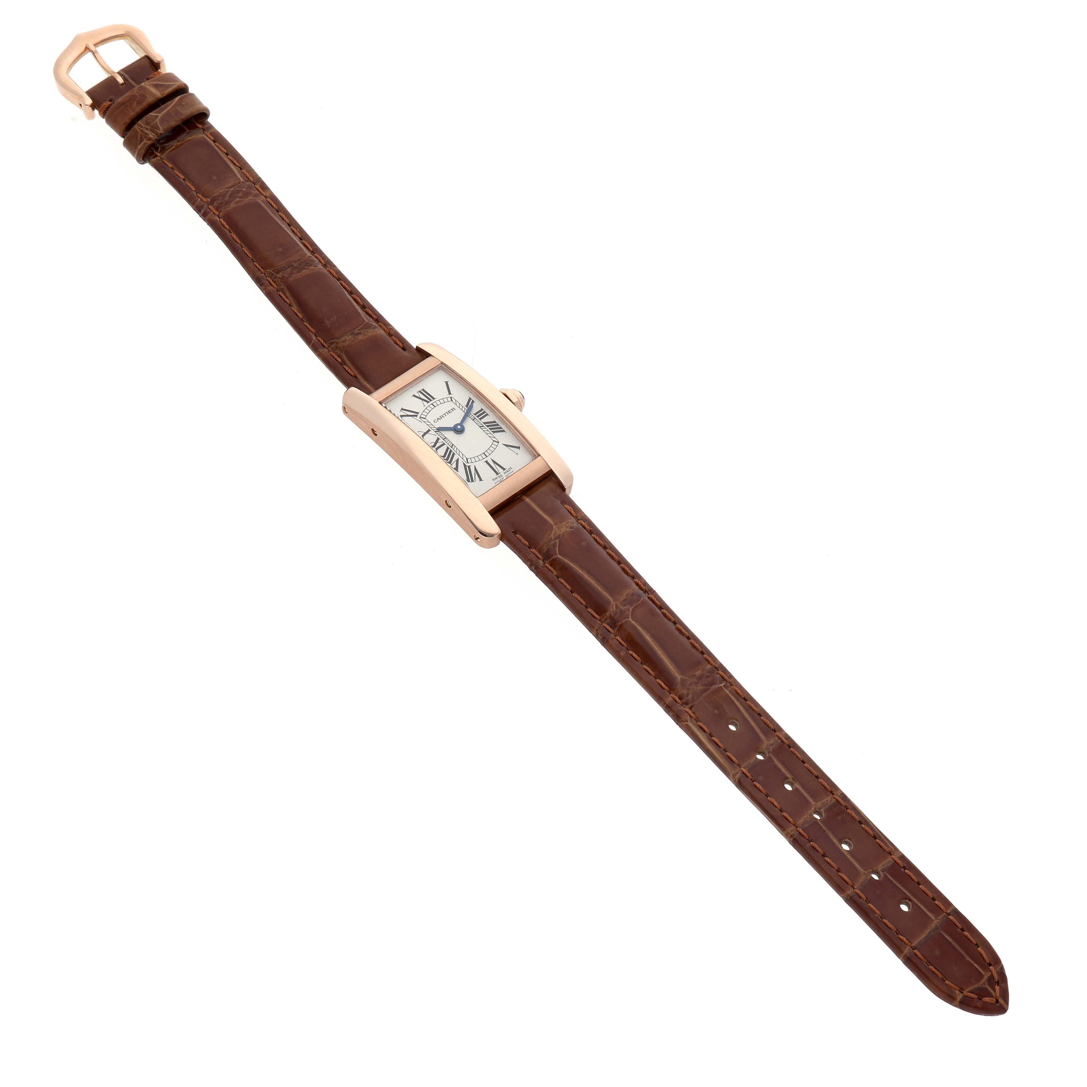 The Cartier Tank Americaine W2607456 Women's Rose Gold Silver Dial watch is shown from a top-down angle, highlighting the rectangular face, brown leather strap, and buckle.