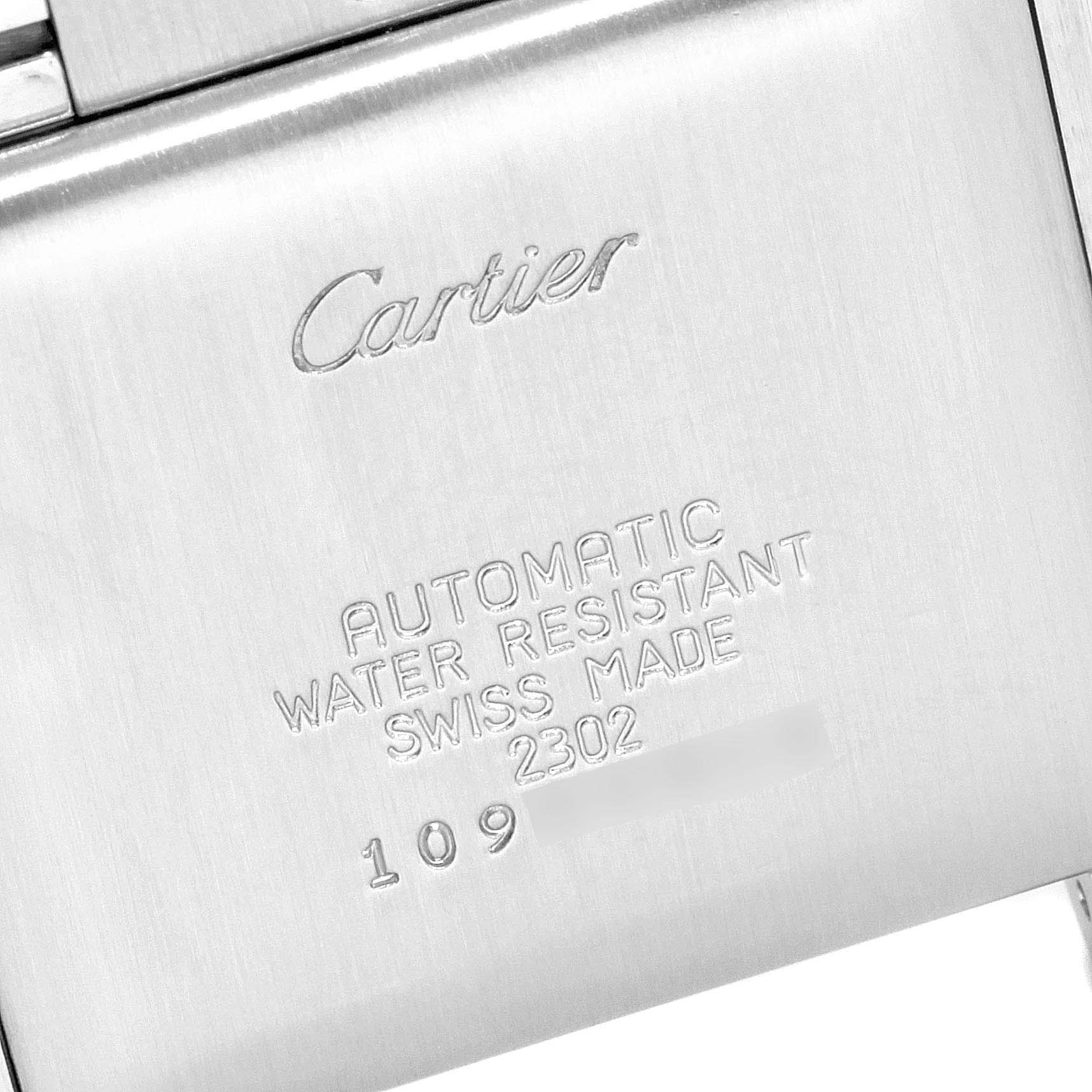This image shows the back case of the Cartier Tank Française watch, displaying engraved details.