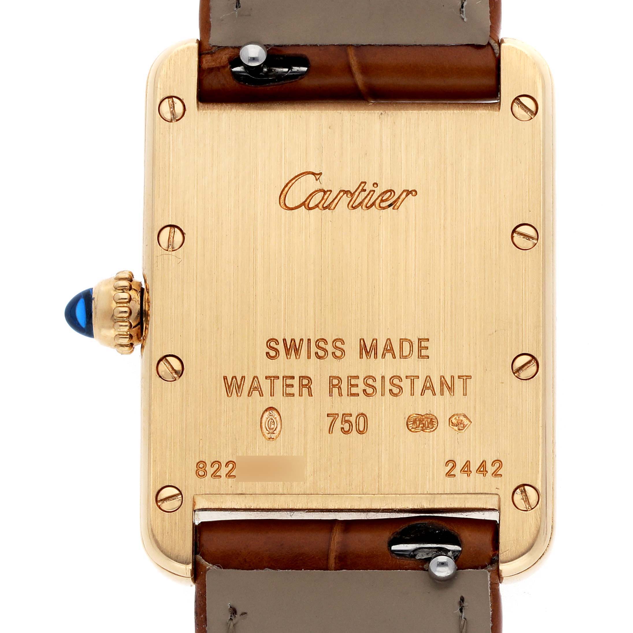 The image shows the back of the Cartier Tank Louis W1529856 Women
s Yellow Gold Silver Dial watch, highlighting the engravings and crown with a blue cabochon.