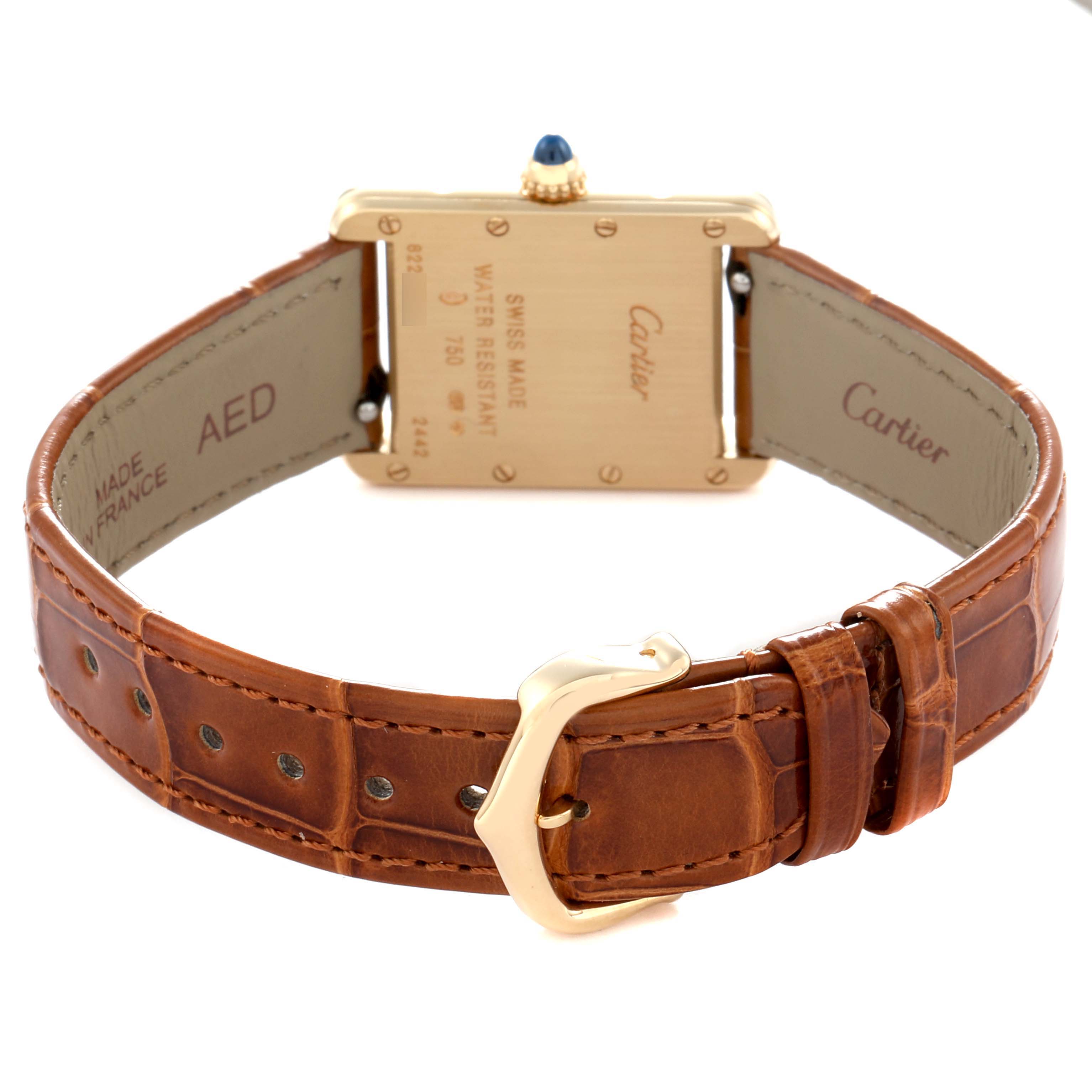 The image shows the back of a Cartier Tank Louis W1529856 Women
s Yellow Gold Silver Dial watch, highlighting the leather strap and engraved case.