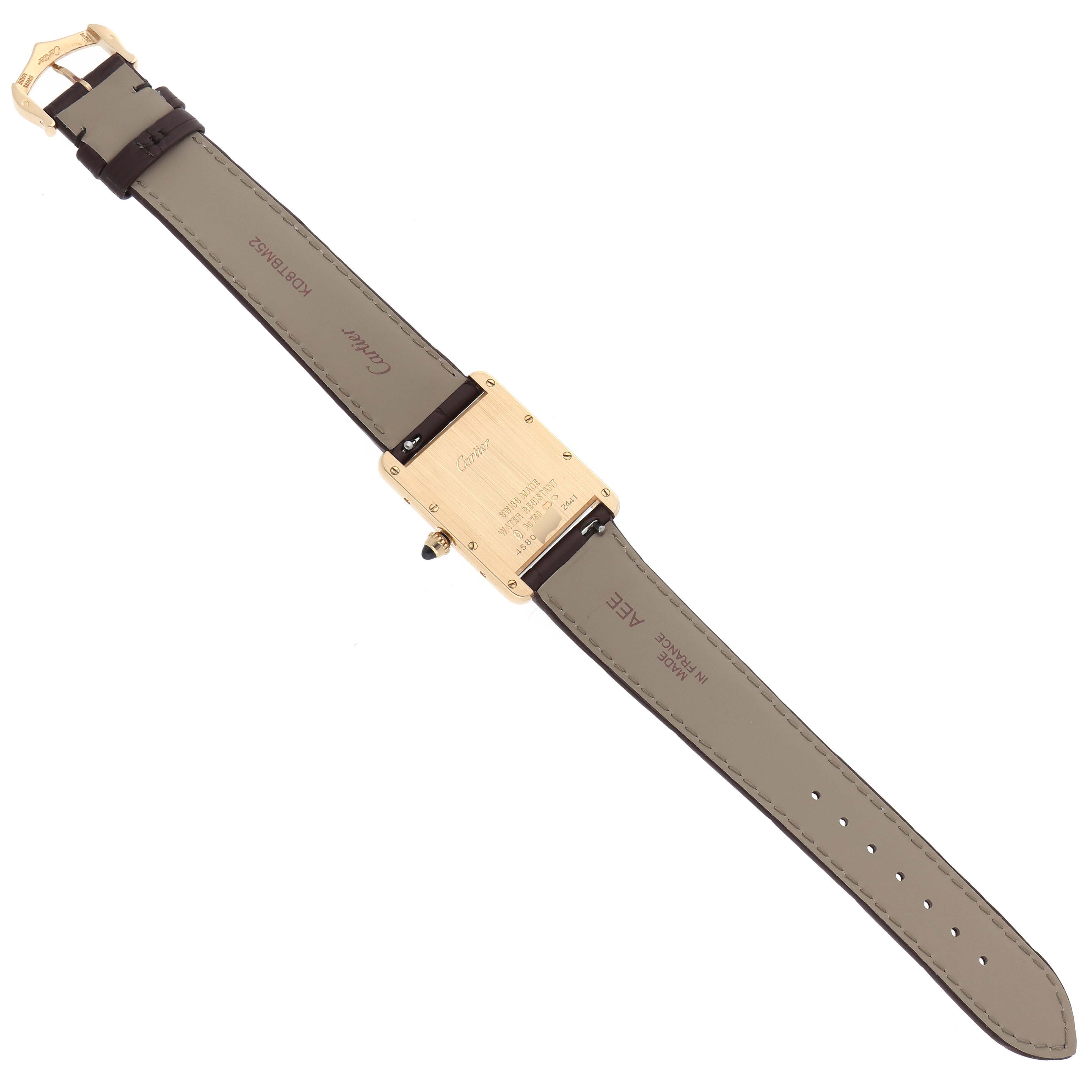 The image shows the Tank Louis watch by Cartier from the rear, highlighting the back case and leather strap.