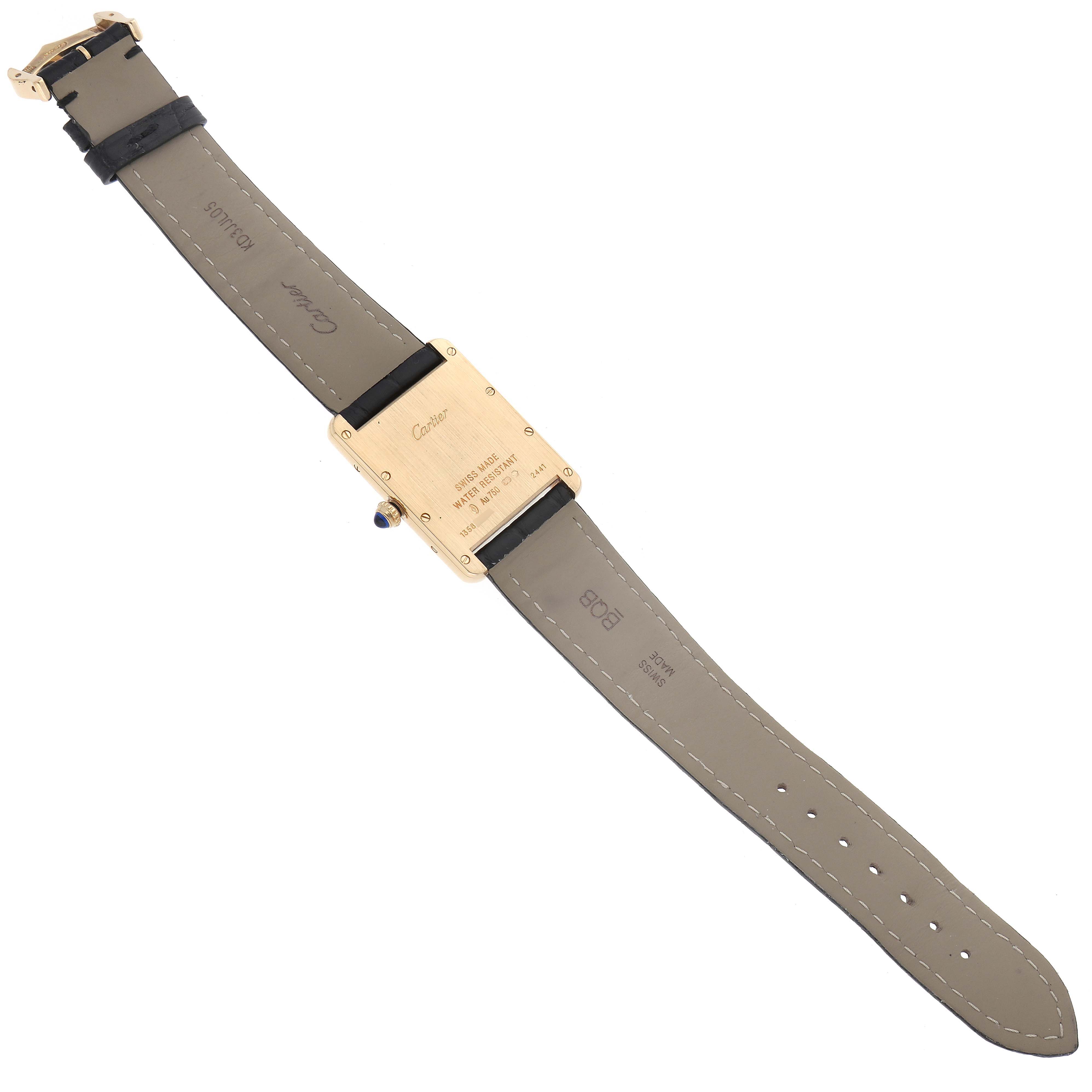 The image shows the back view of a Tank Louis model watch by Cartier, highlighting the case back, strap, and buckle.