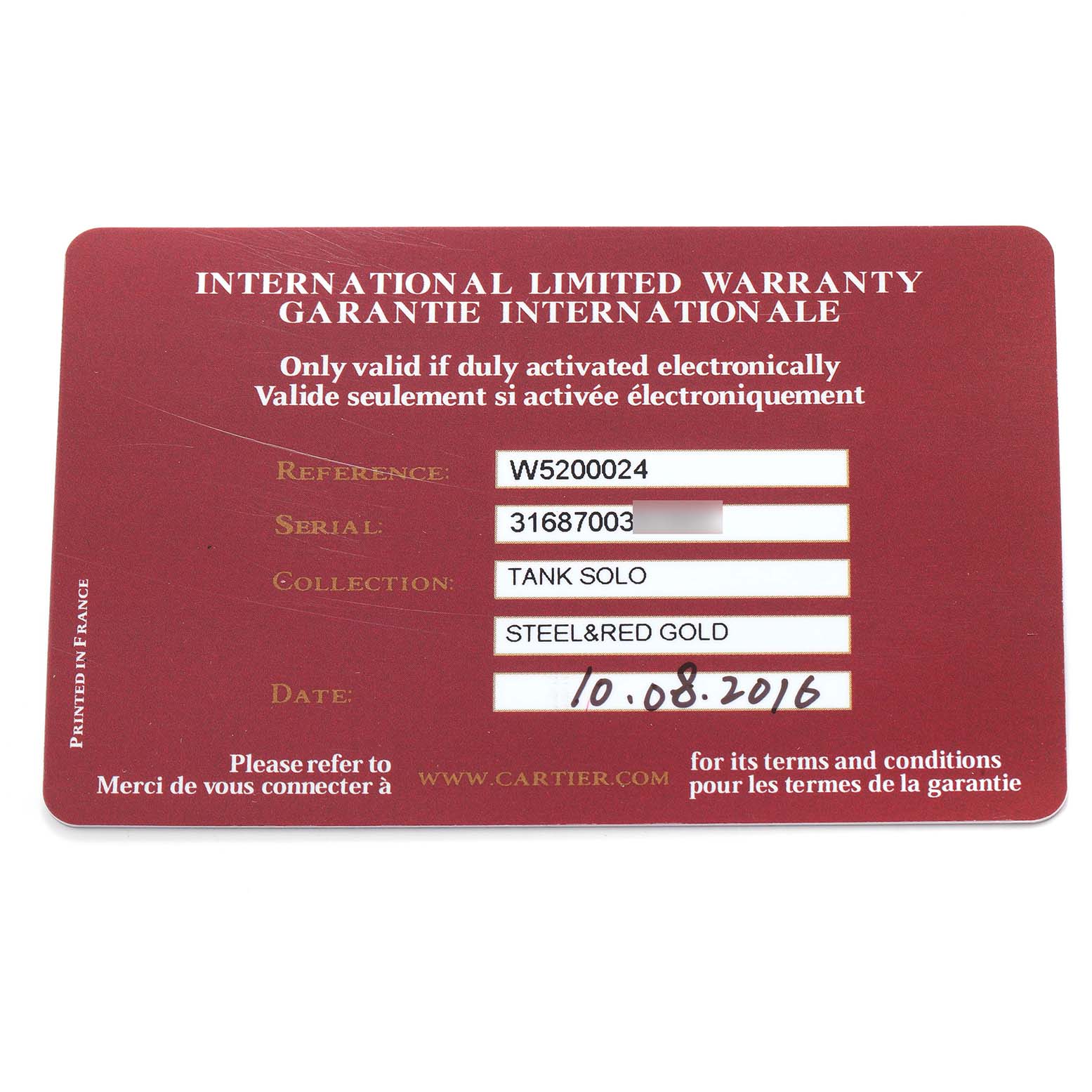 The image shows an international limited warranty card for the Cartier Tank Solo model W5200024, indicating serial number and collection details.