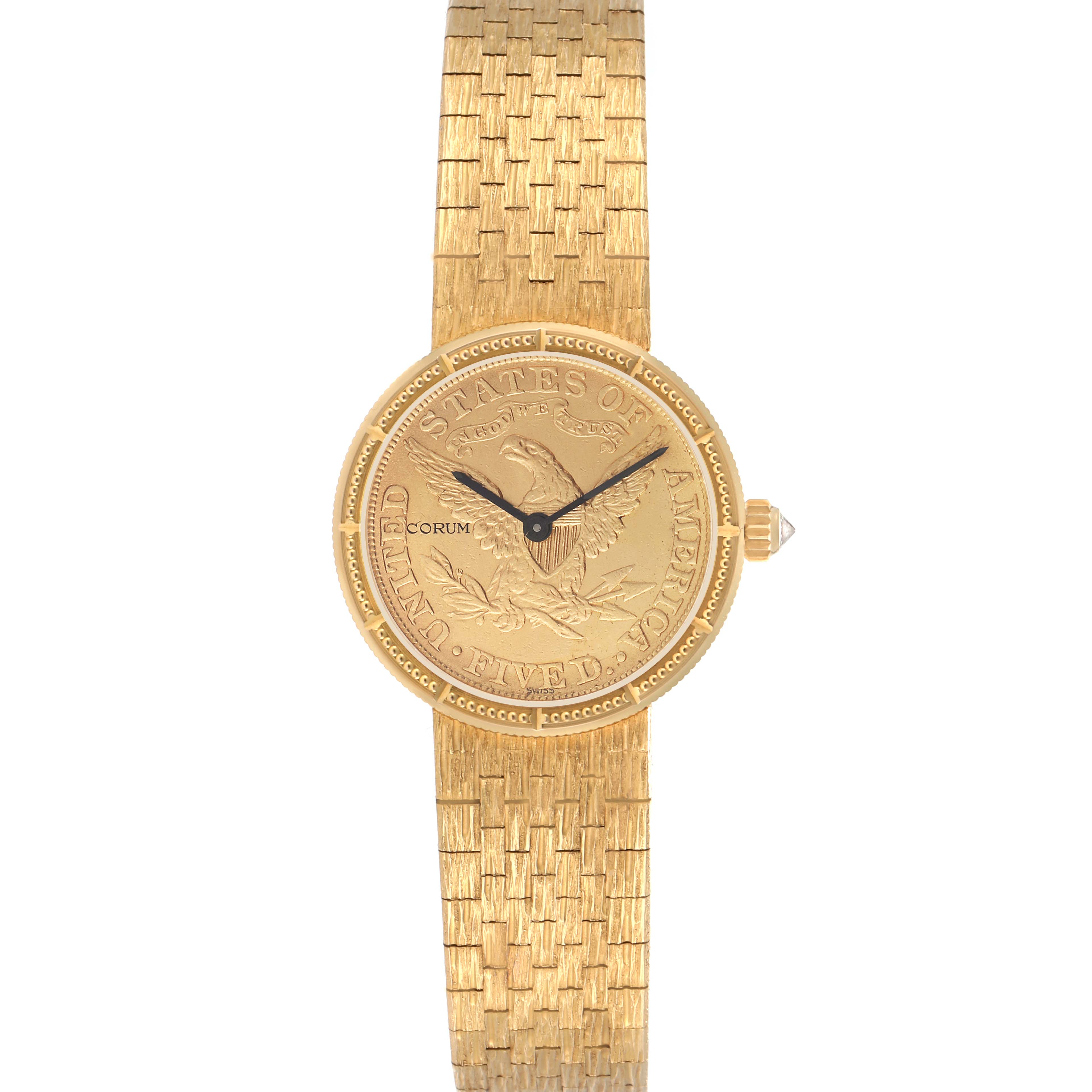 The Corum 1892 YEAR men
s watch is shown from a top-down angle, featuring its engraved gold dial and textured gold bracelet.