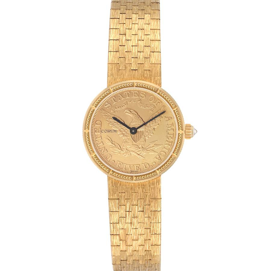 The Corum 1892 YEAR men's watch is shown from a top-down angle, featuring its engraved gold dial and textured gold bracelet.