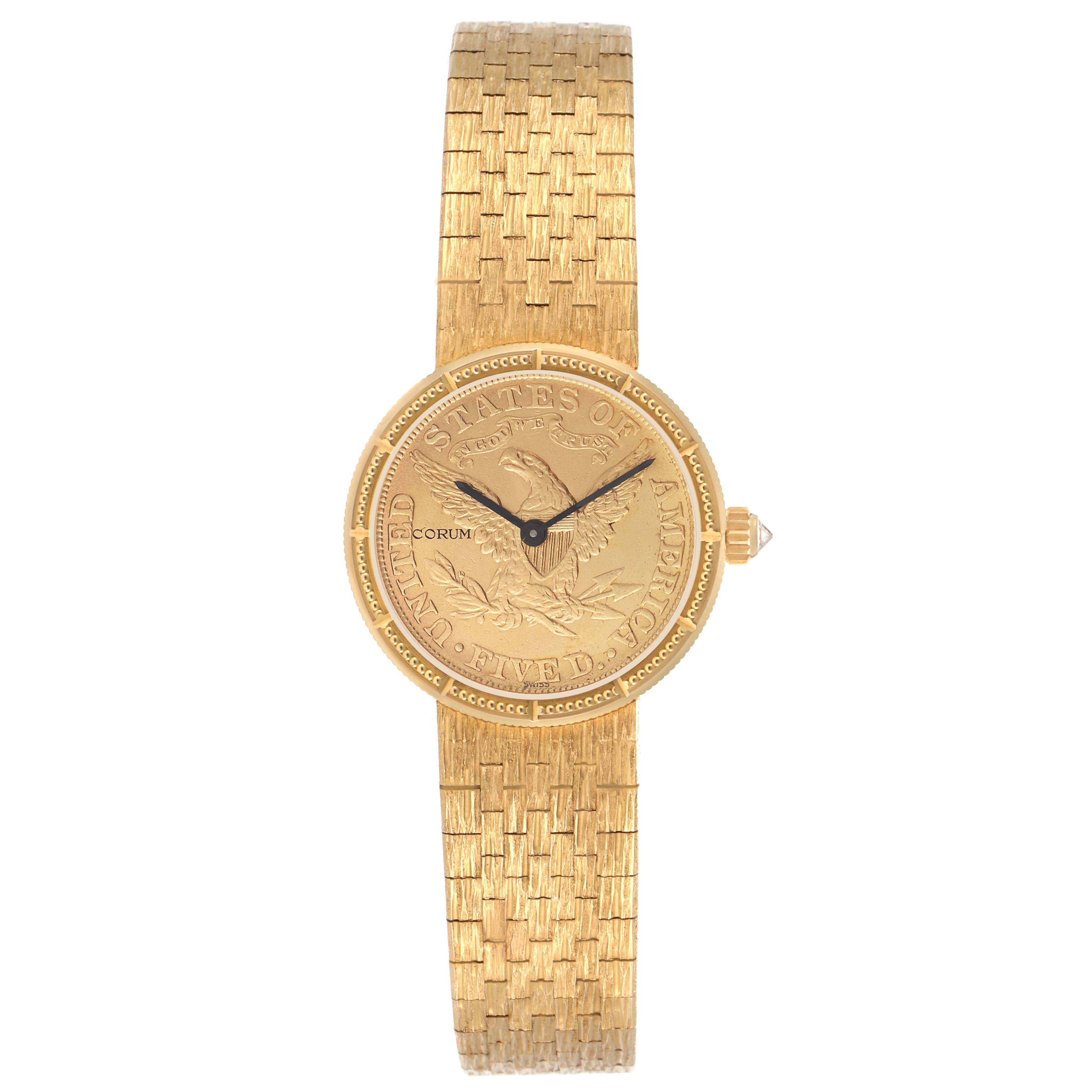 The Corum model 1892 YEAR men
s watch is shown from a top-down angle, displaying its engraved face, gold bracelet, and crown on the side.