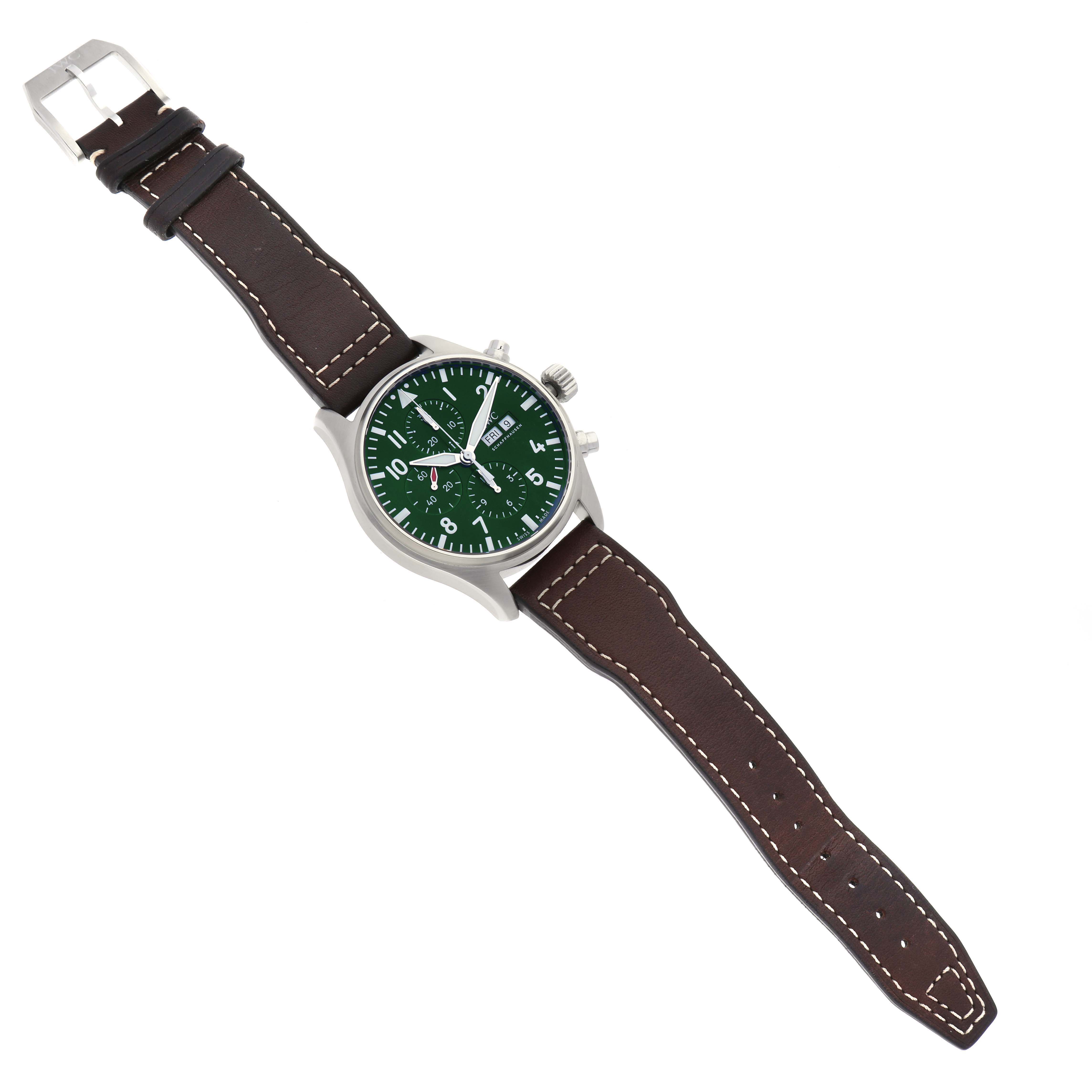 The IWC Pilot IW377726 Men's Stainless Steel Green Dial IW377726 Men's Stainless Steel Green Dial watch is shown from an overhead view, featuring its green dial, crown, pushers, and brown leather strap with white stitching.