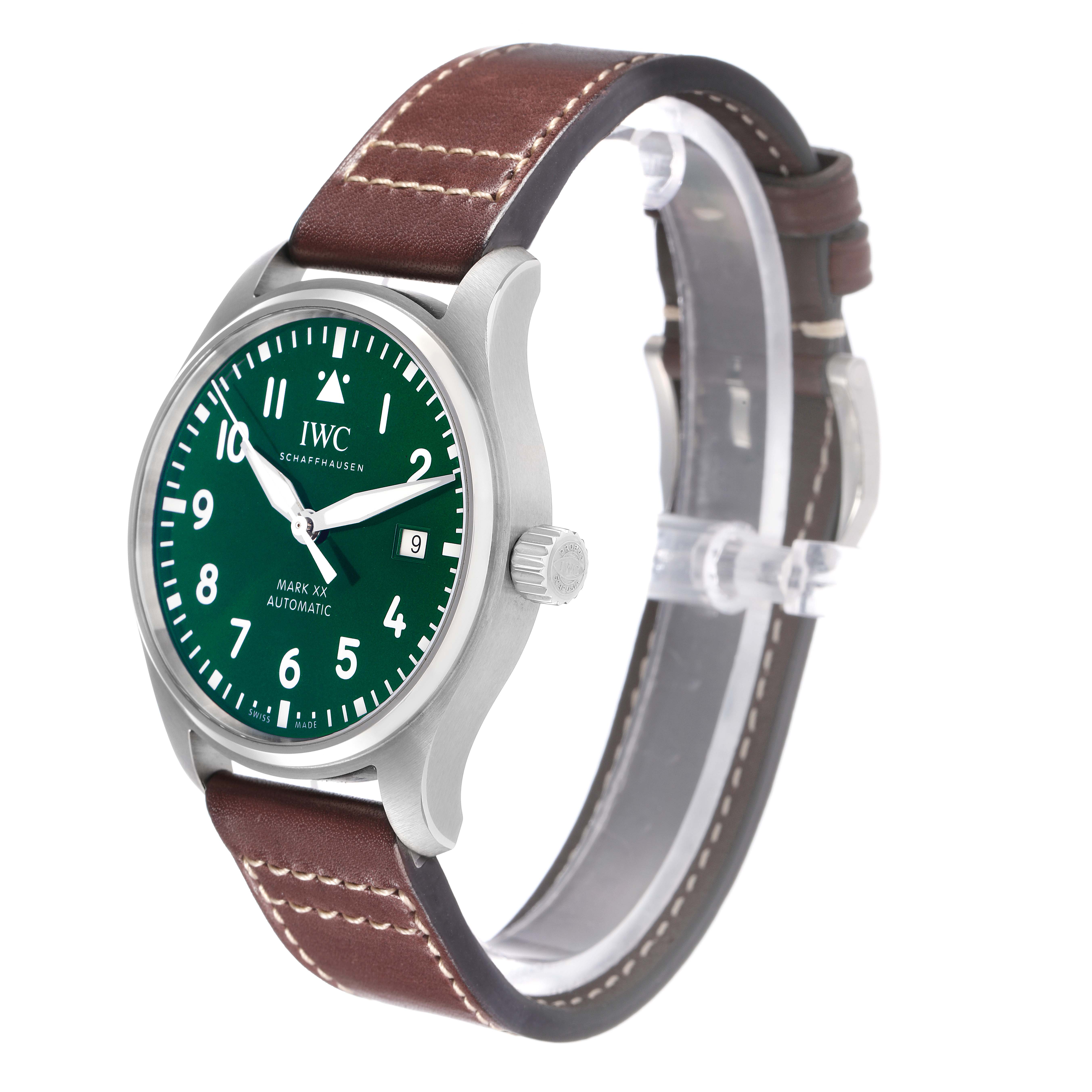 The IWC Pilot watch model IW329702 is shown at a three-quarter angle, highlighting the green dial, silver case, crown, and brown leather strap.