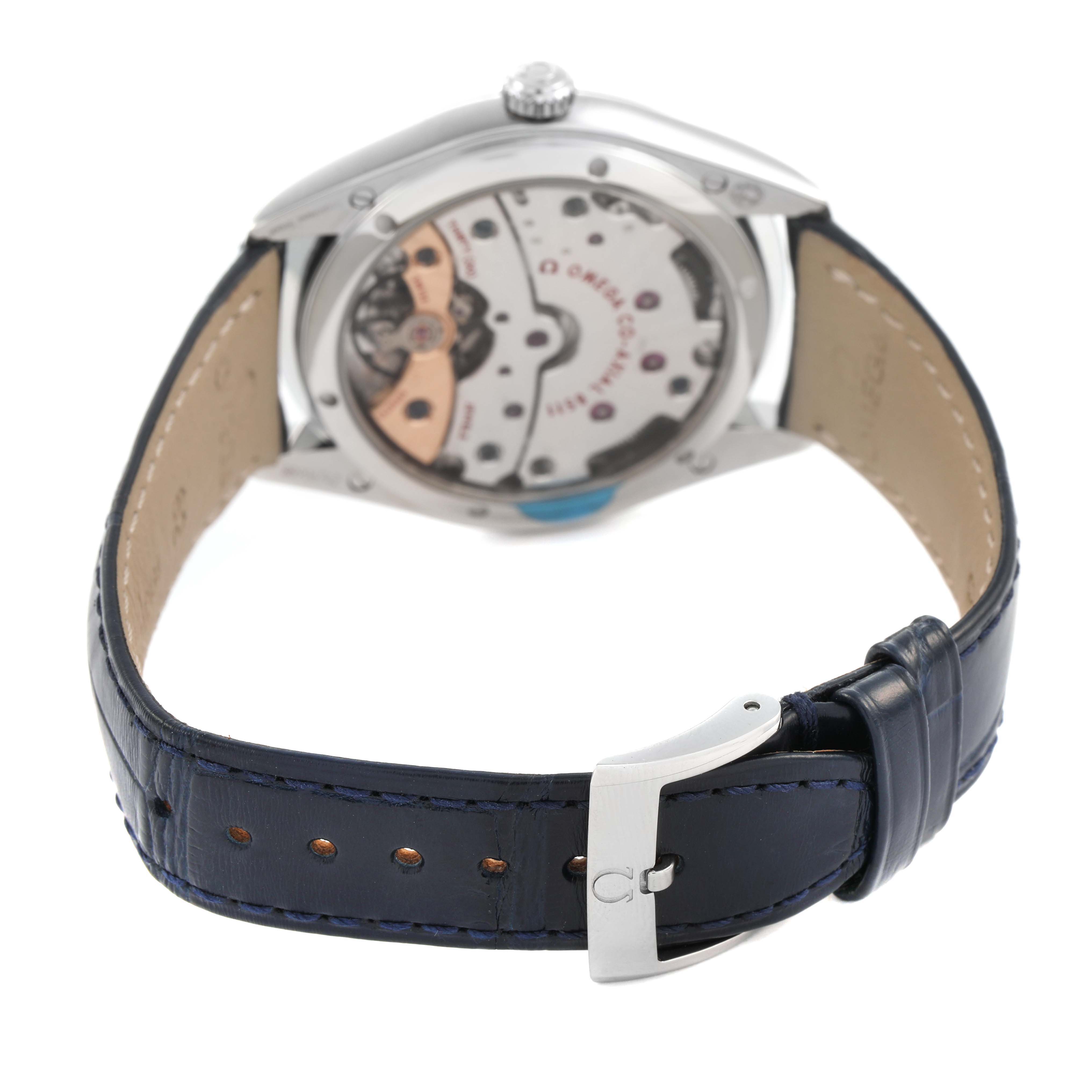 The image shows the back view of an Omega De Ville 432.18.40.21.03.001 Men's Stainless Steel Blue Dial watch, highlighting its movement and leather strap with a buckle.
