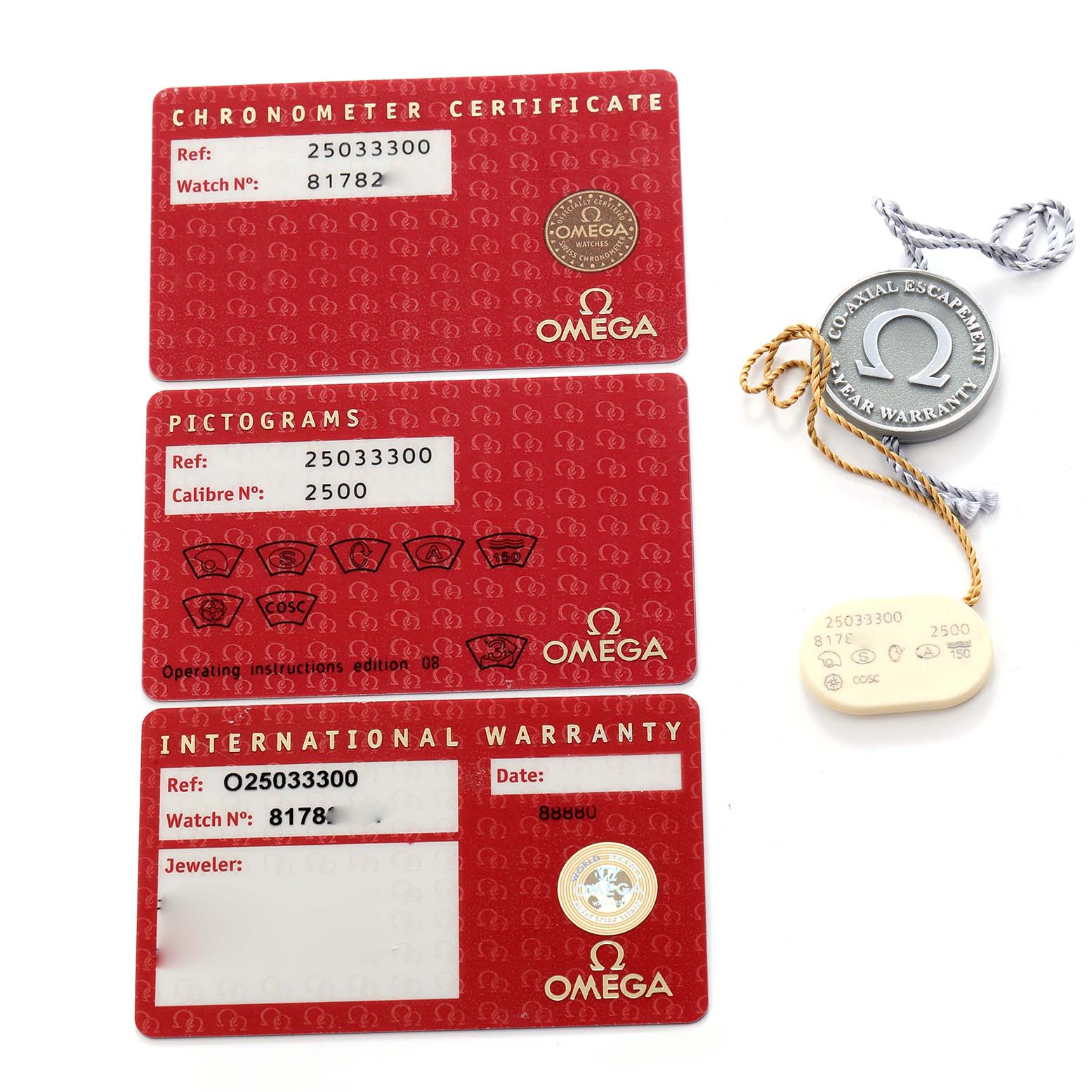 The image shows Omega Seamaster model 2503.33.00 accessories, including red cards for warranty and certification, and a metal tag with strings.