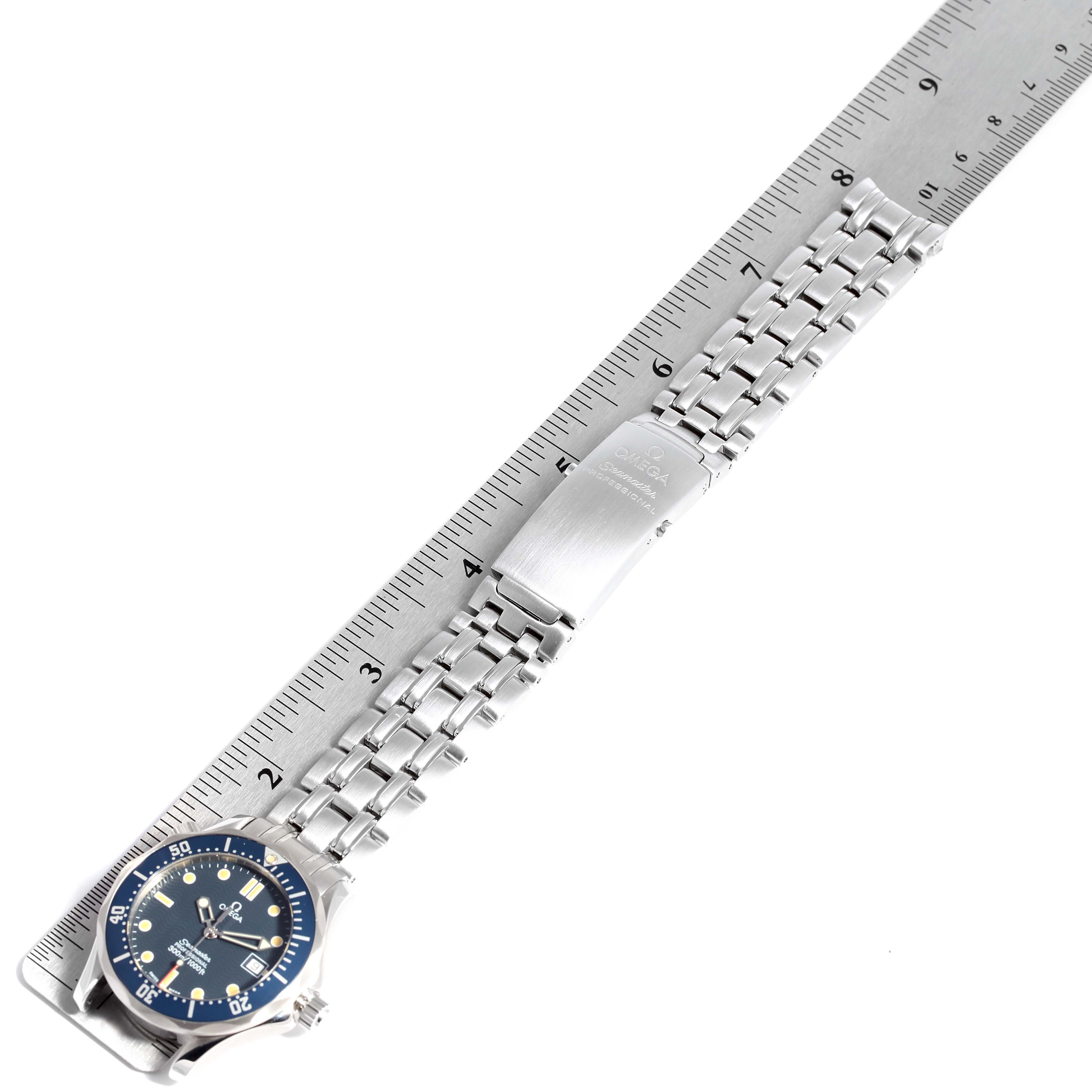 This image shows an Omega Seamaster 2561.80.00 Men
s Stainless Steel Blue Dial 2561.80.00 Men
s Stainless Steel Blue Dial watch laid flat against a ruler, highlighting the face and metal bracelet.