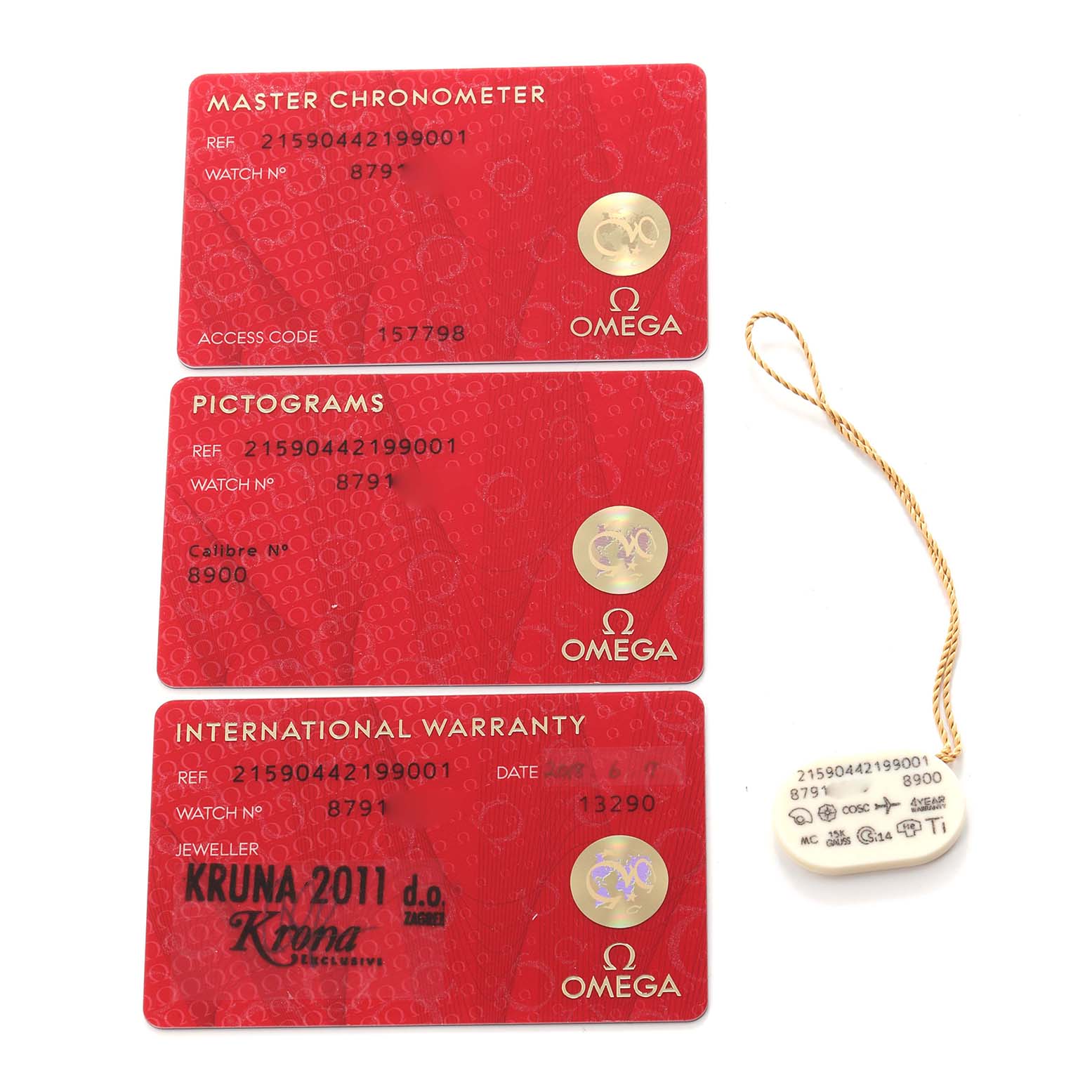 The image shows three red cards and a tag related to the Omega Planet Ocean model 215.90.44.21.99.001, including a Master Chronometer, Pictograms, and International Warranty card.