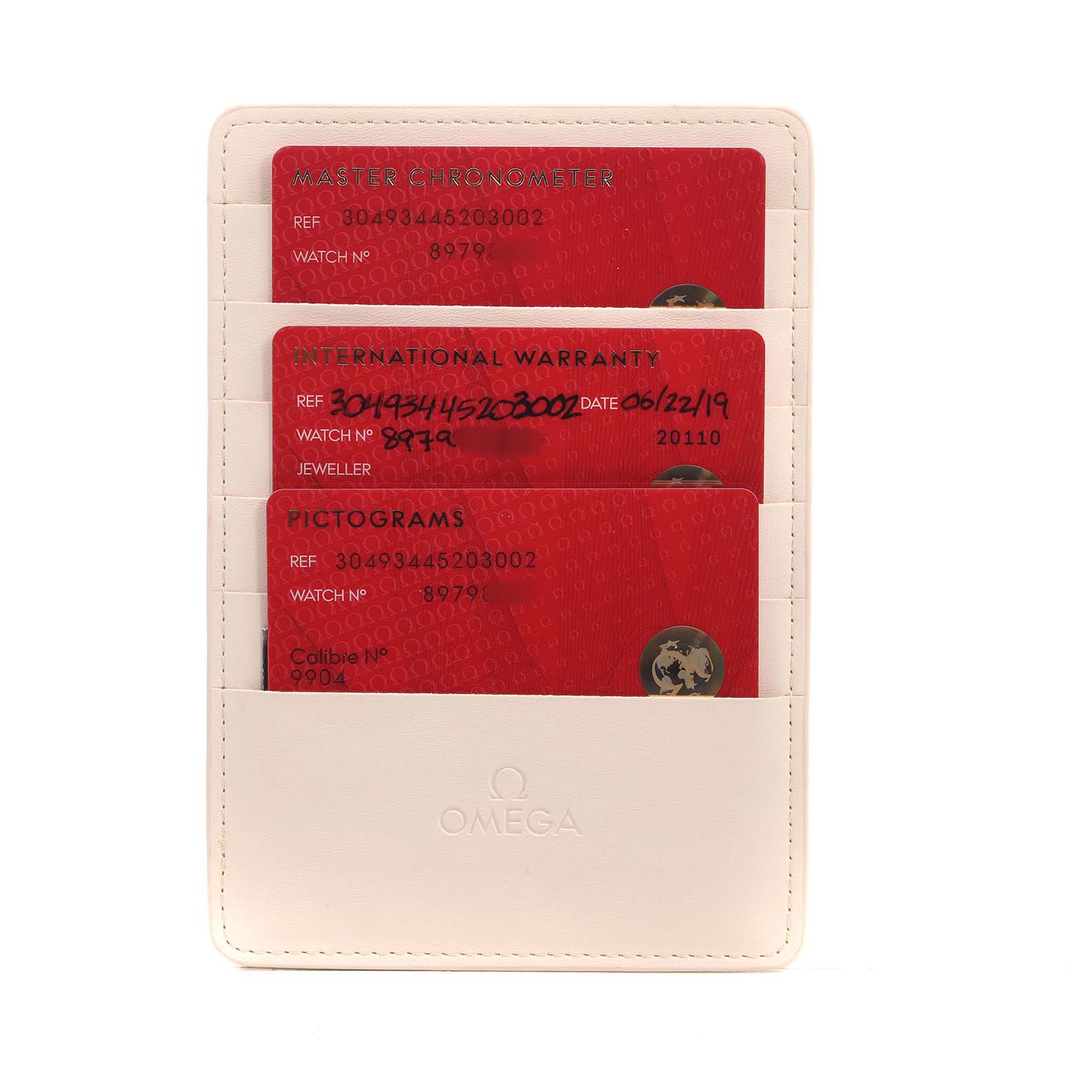 The image shows three Omega Speedmaster 304.93.44.52.03.002 Men's Ceramic Blue Dial warranty cards in a cardholder.