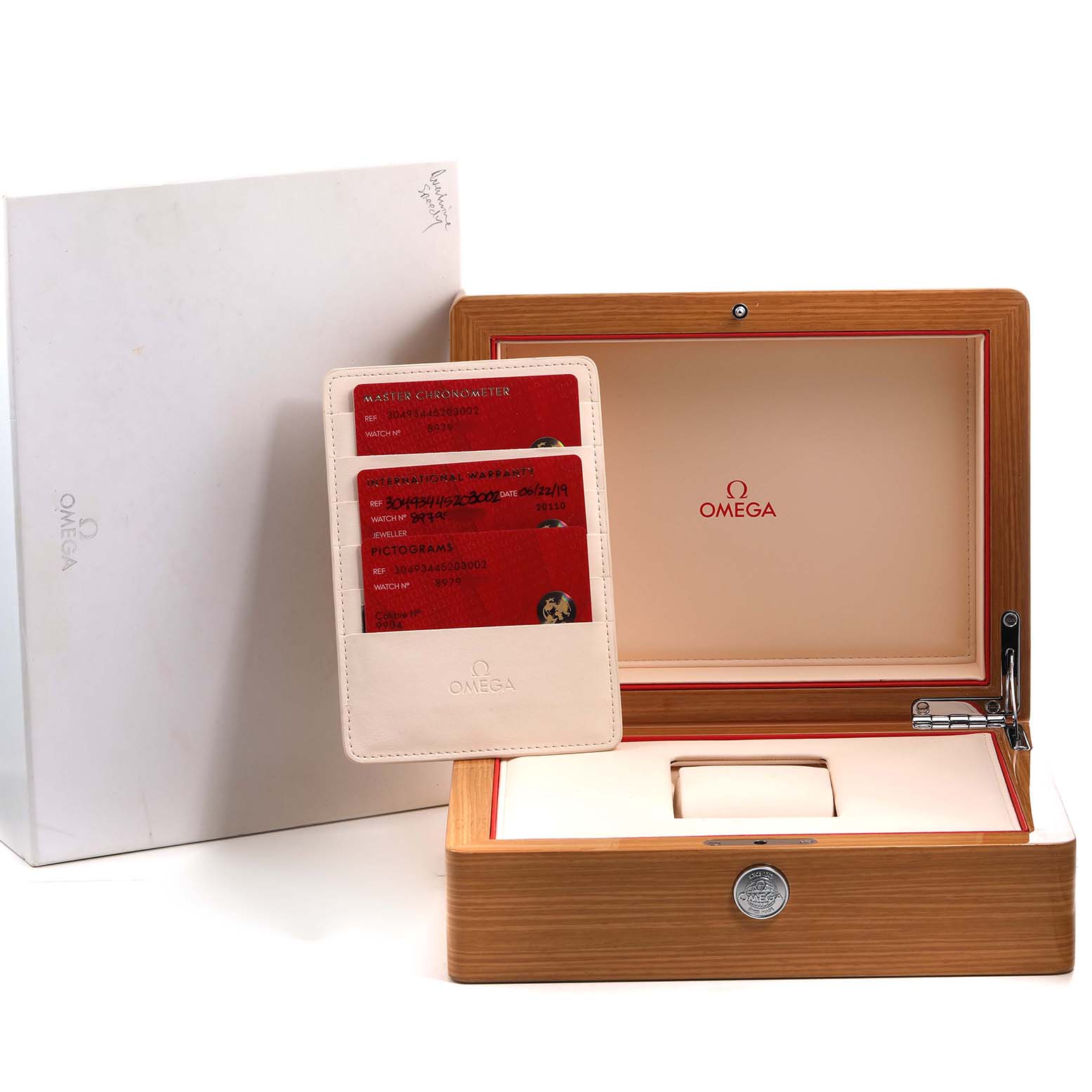 The image shows an Omega Speedmaster 304.93.44.52.03.002 Men's Ceramic Blue Dial watch box, authenticity cards, and a storage slot.