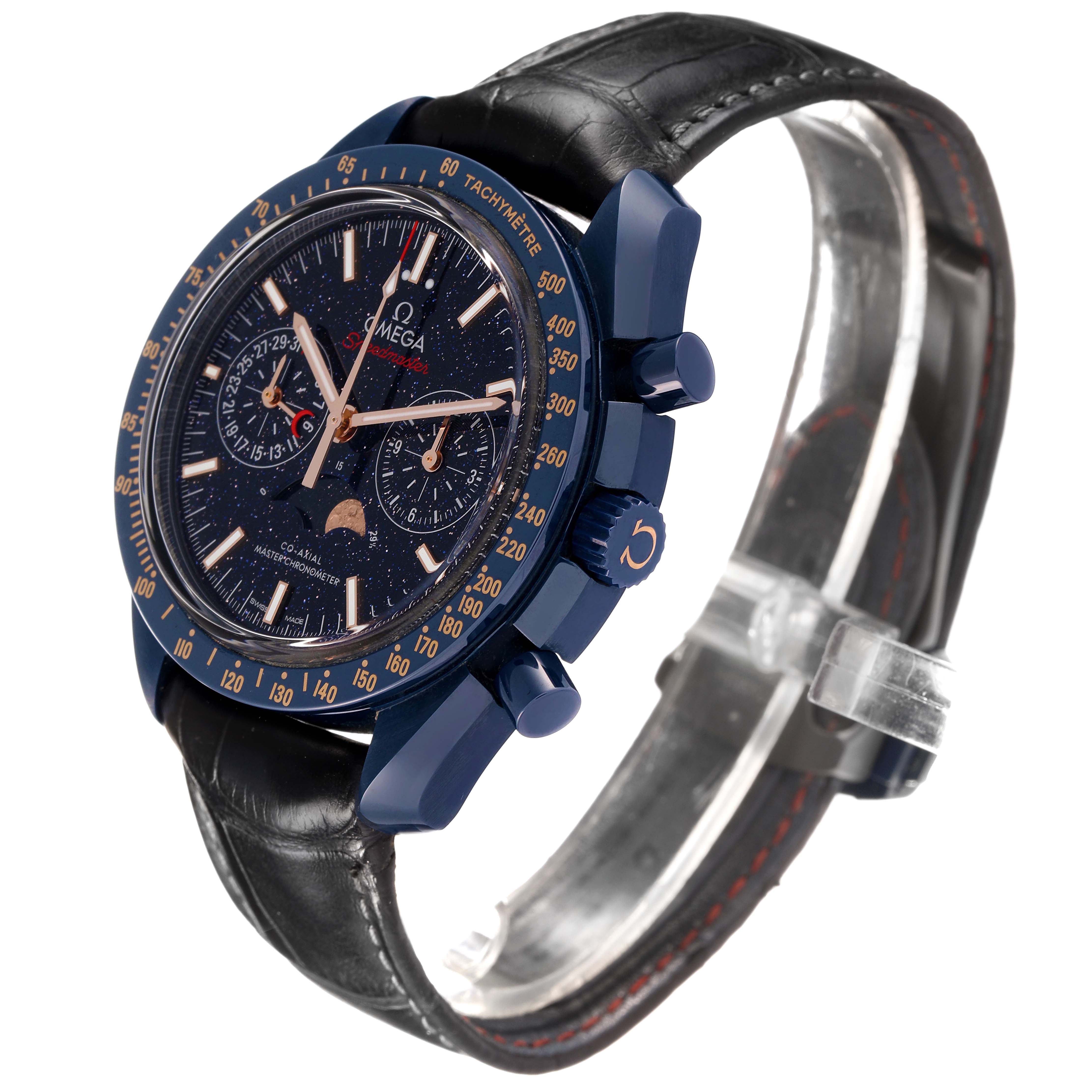 The Omega Speedmaster 304.93.44.52.03.002 Men's Ceramic Blue Dial watch is shown at a three-quarter angle, highlighting the dial, bezel, pushers, and leather strap.