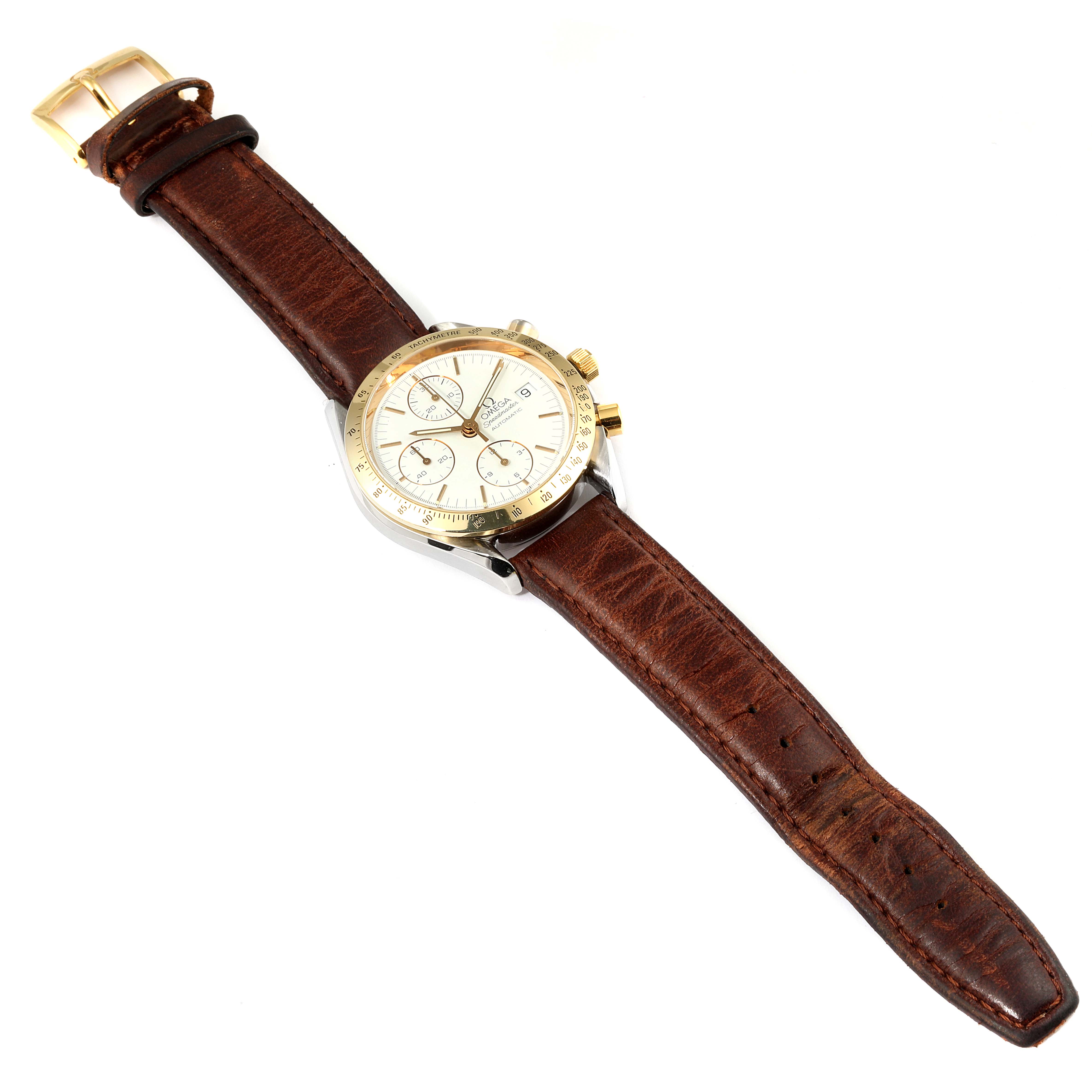 The Omega Speedmaster 3311.20.00 Men's Steel and Gold (two tone) White Dial 3311.20.00 Men's Steel and Gold (two tone) White Dial watch is shown at a slight angle, displaying the dial, bezel, and brown leather strap.