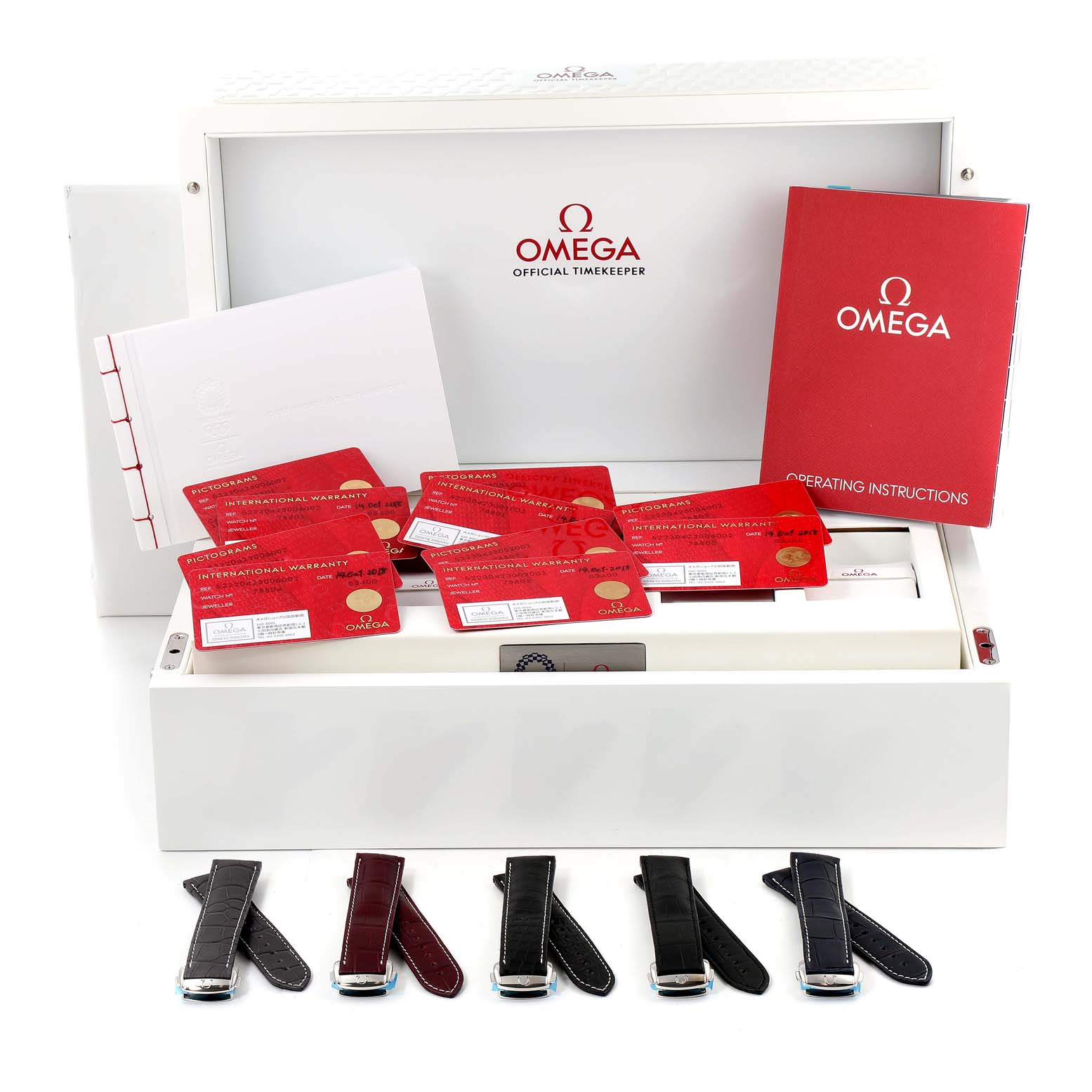 The image shows a collection of Omega Speedmaster 522.20.42.30.06.001 Men's Stainless Steel Black Dial 522.20.42.30.06.001 Men's Stainless Steel Black Dial accessories, including straps, instruction booklets, and warranty cards, displayed in an open box.