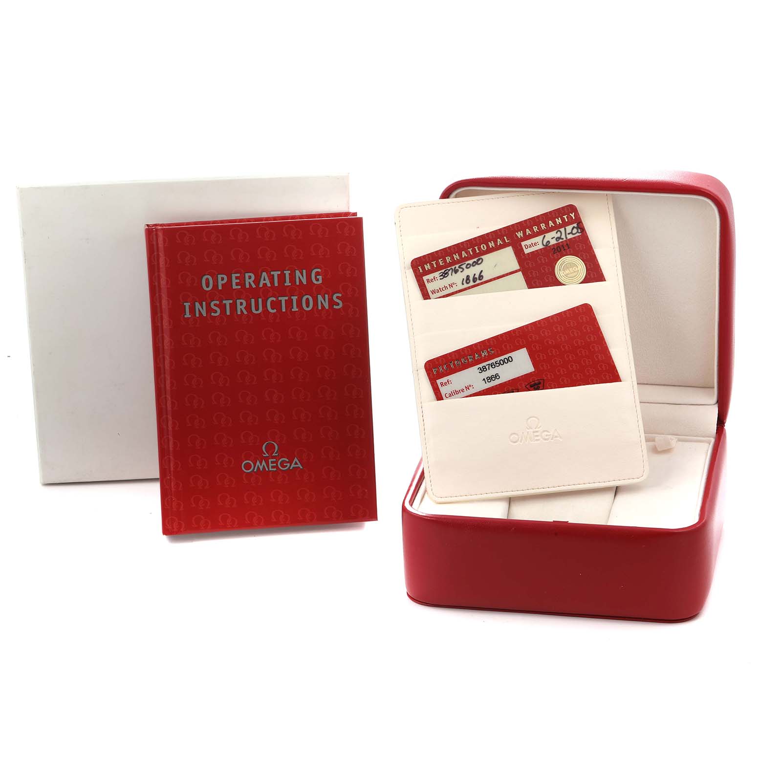 The image shows Omega Speedmaster 3876.50 Men
s Stainless Steel Black Dial accessories, including a red manual, warranty cards, and a watch box, viewed from the front.