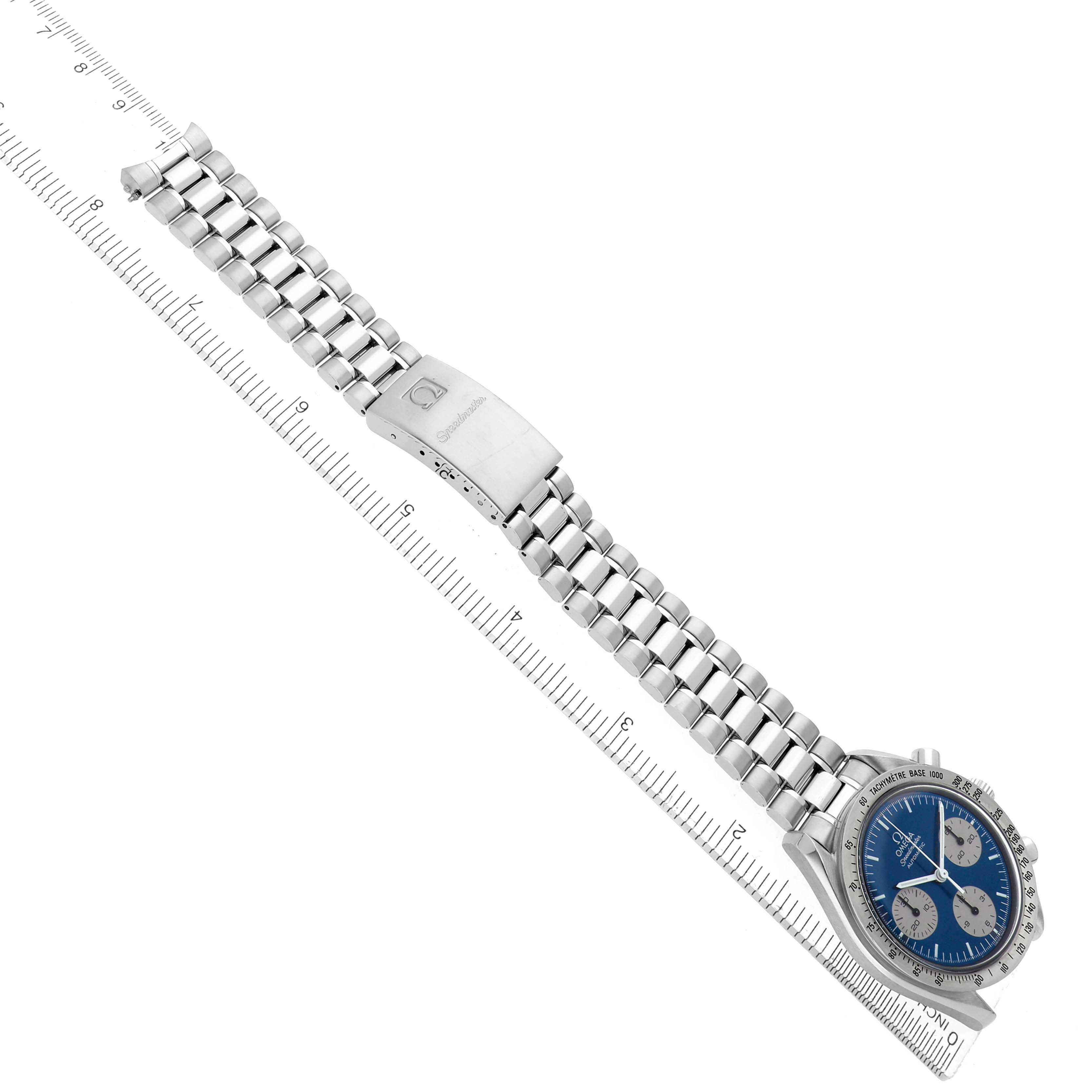 The image shows the Omega Speedmaster model 3510.82.00 watch laid flat with its full stainless steel bracelet and clasp visible, along with its blue dial.