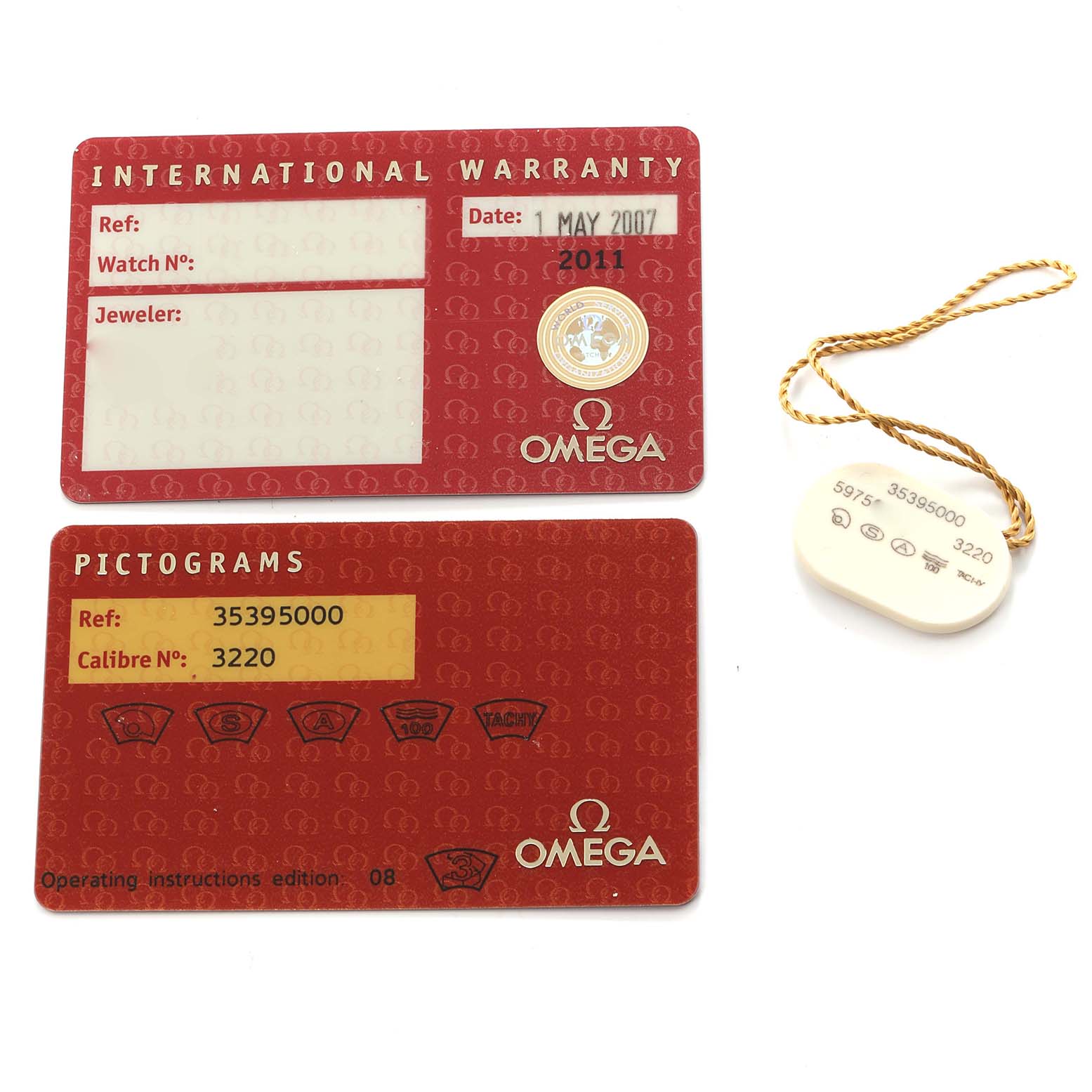 The image shows accessories for the Omega Speedmaster model 3539.50.00, including an international warranty card, a pictogram card, and a tag.